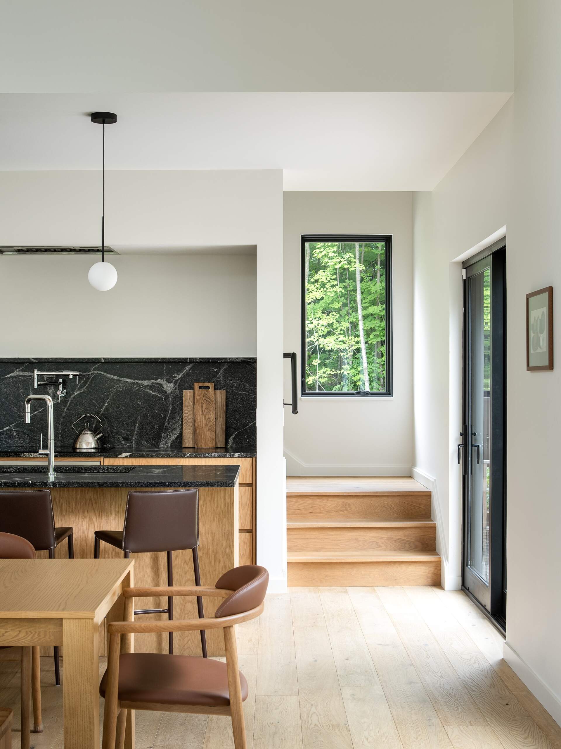 Follow the stairs through this Vermont hillside home, where changing levels, offset volumes and shifting ceiling heights make moving between floors part of the architectural experience.