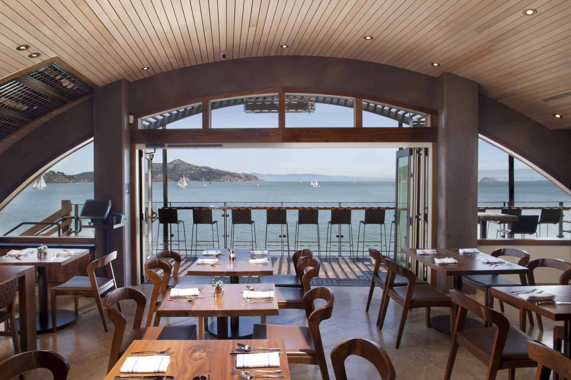 See how a former Sausalito ferry terminal was transformed into Barrel House Tavern while retaining historic features including expansive windows, cement plaster arches, and a reclaimed maple ceiling.