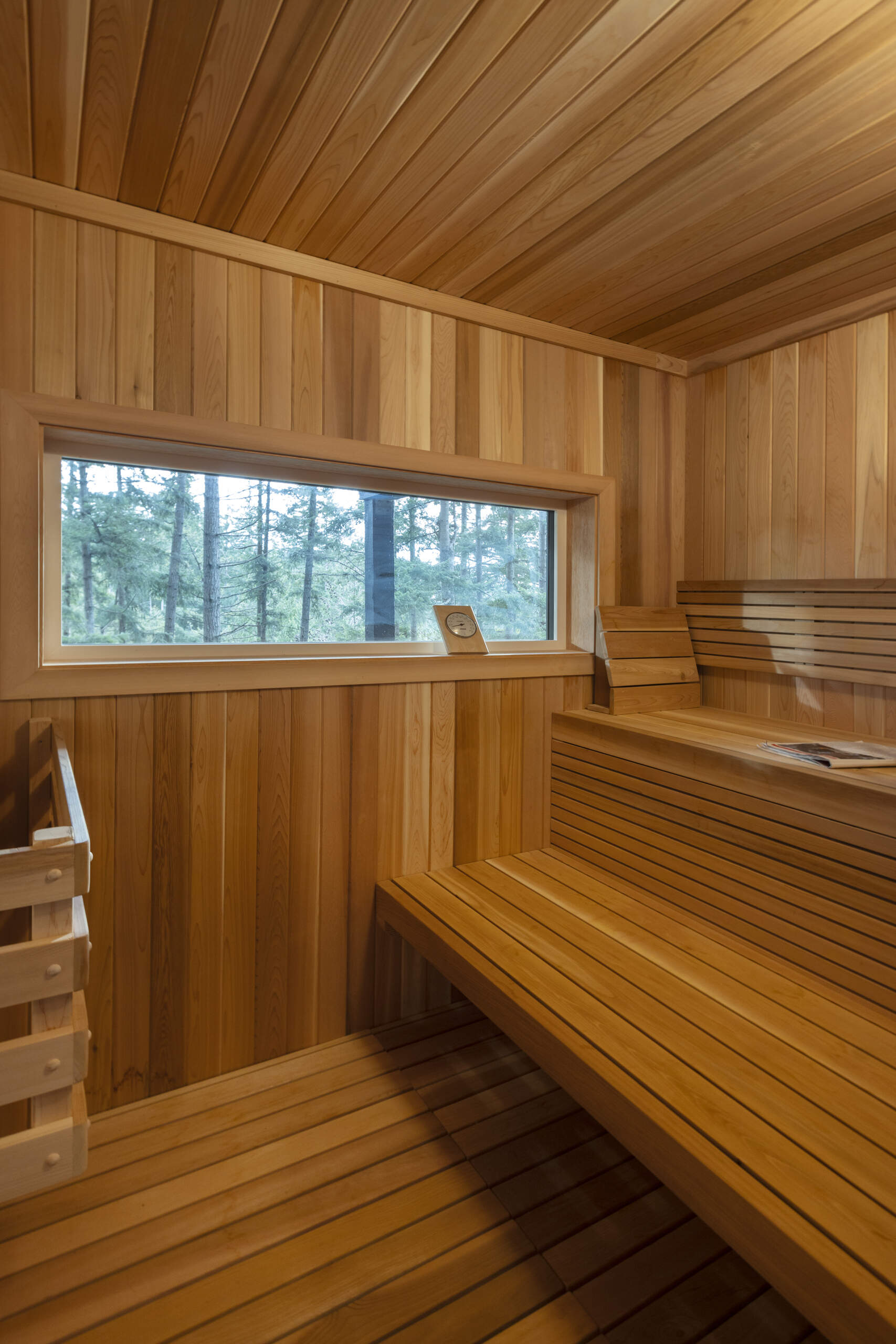 An existing sauna was refurbished and reclad in cedar, adding a warm natural finish to the lower level of Westport Place House and creating a relaxing space after mountain hikes.