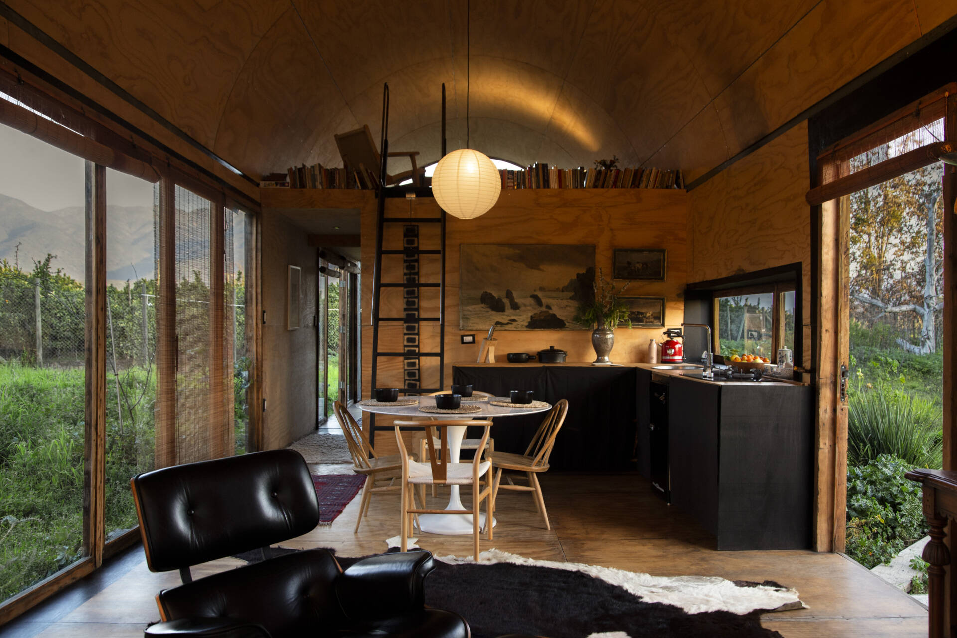 The kitchen in this tiny house places nature front and centre, using carefully framed views that change with every season.