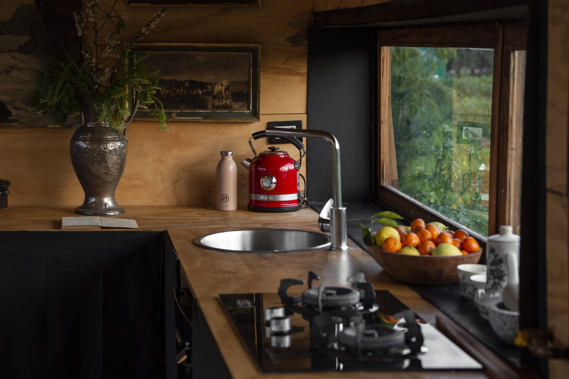 The kitchen in this tiny house places nature front and centre, using carefully framed views that change with every season.
