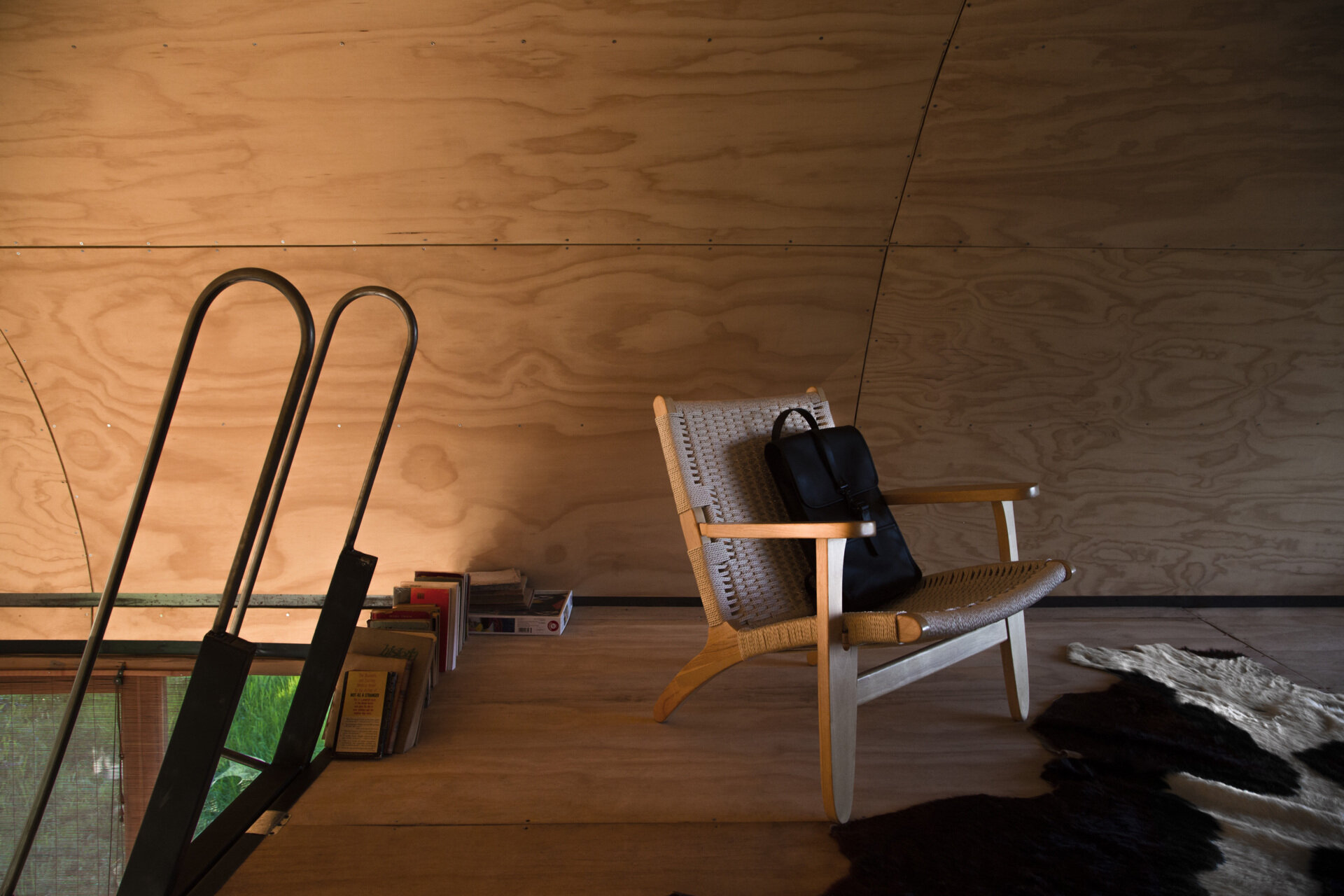 Positioned beneath the vaulted ceiling, this loft in a tiny house offers another unique vantage point across the surrounding landscape.
