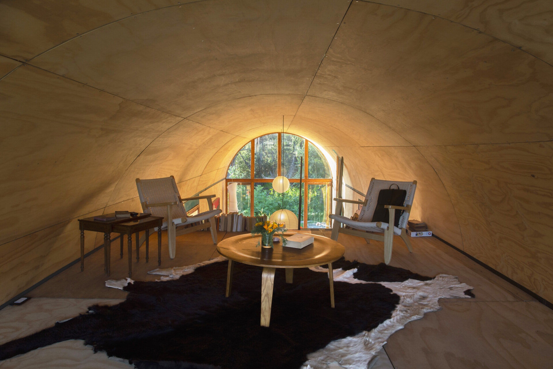 Positioned beneath the vaulted ceiling, this loft in a tiny house offers another unique vantage point across the surrounding landscape.