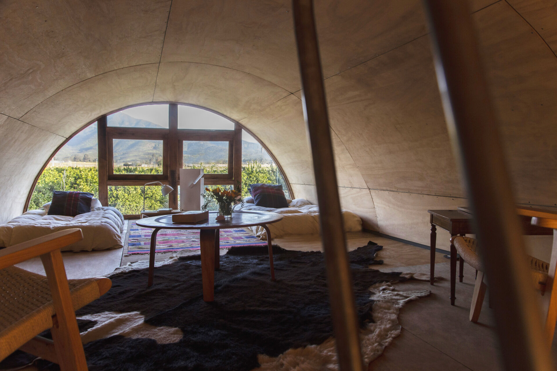 Positioned beneath the vaulted ceiling, this loft in a tiny house offers another unique vantage point across the surrounding landscape.