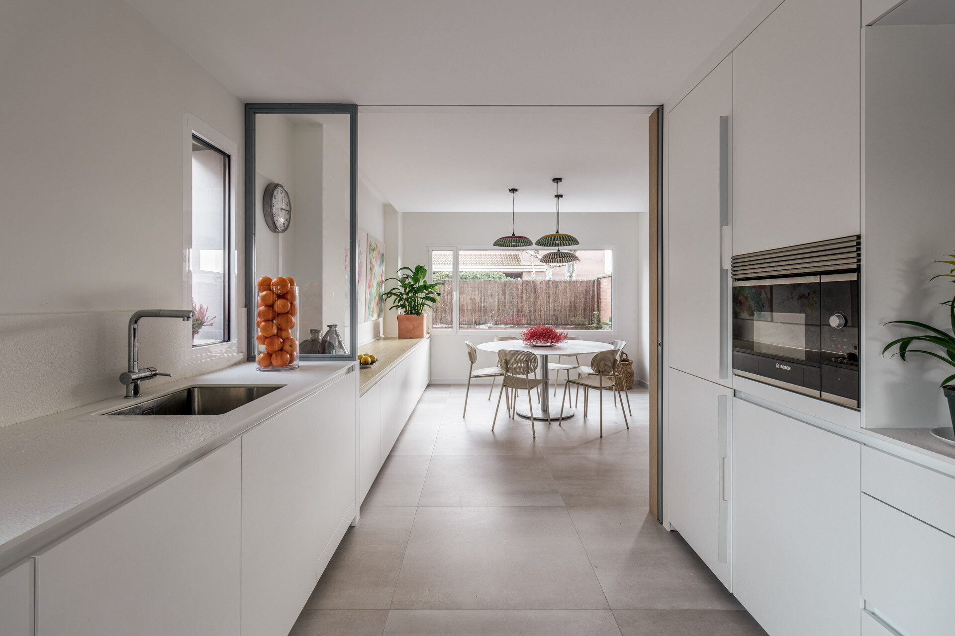 See how the kitchen sits between two dining areas in D + A House, forming the central link within a new open ground-floor layout.