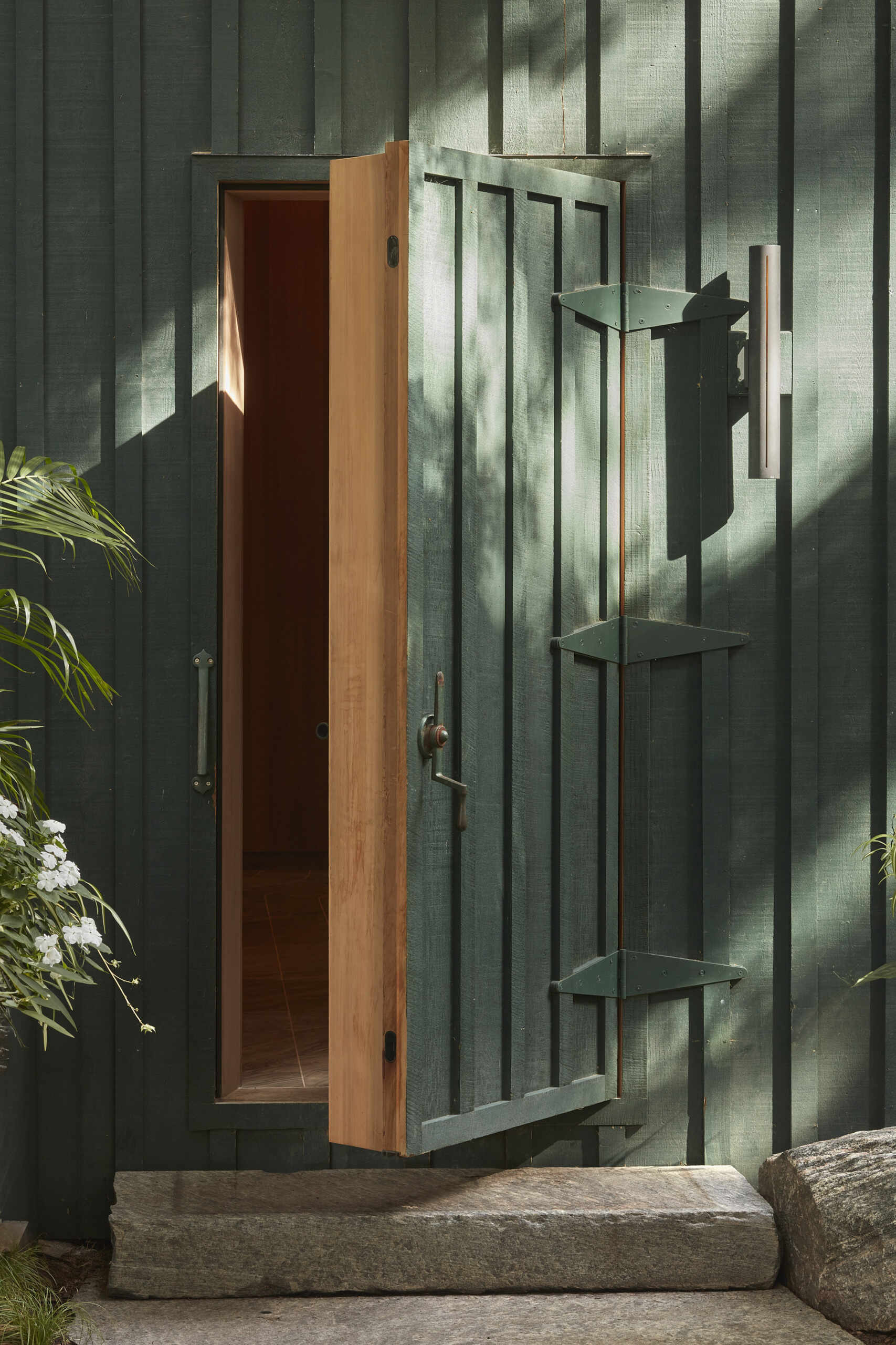PARTISANS transformed a modest ice-storage hut on a Muskoka island into a compact thermal spa filled with carved Canadian Shield granite, custom-milled cedar, a sauna, cold plunge and steam room, as well as an outdoor patio with outdoor shower.