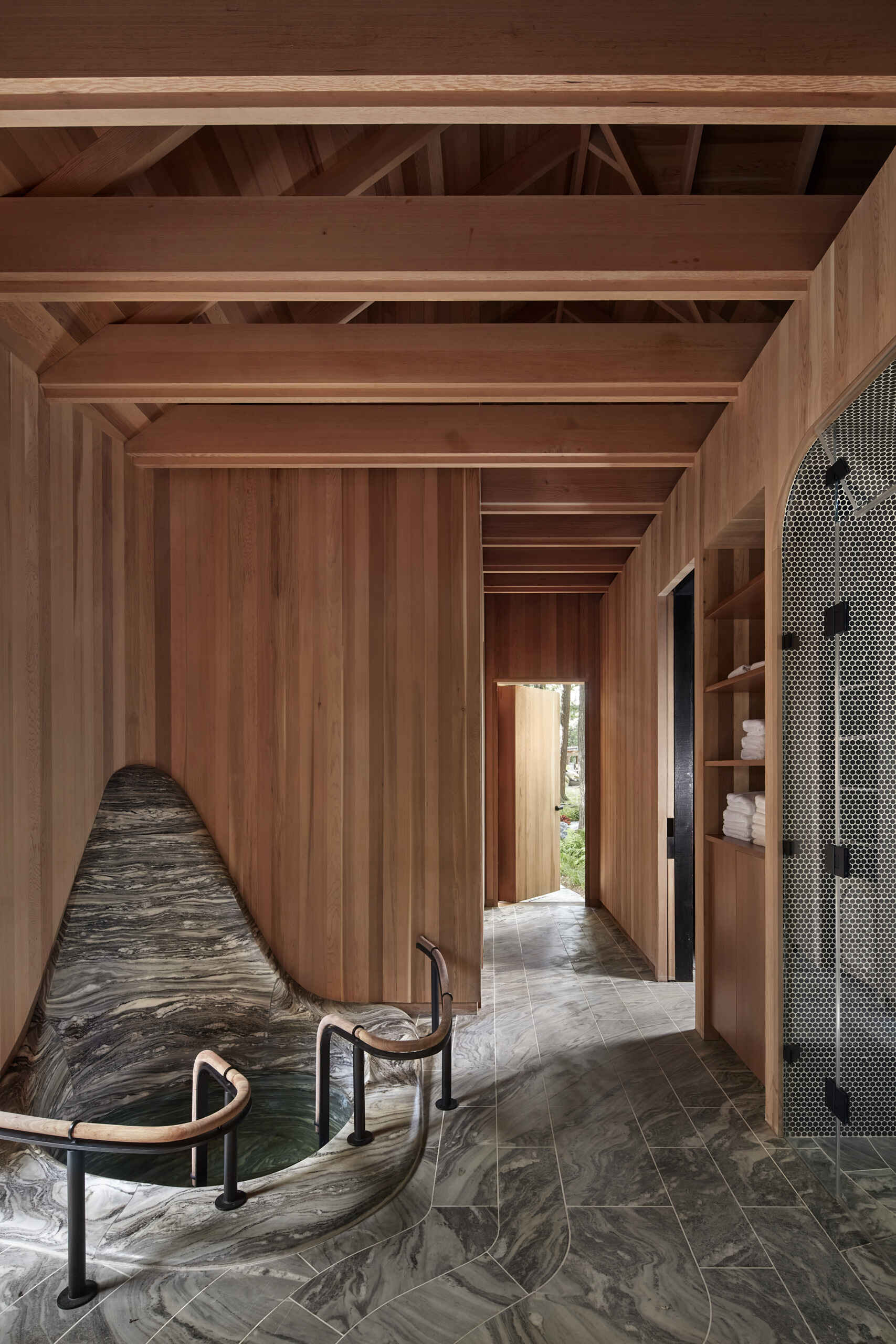 PARTISANS transformed a modest ice-storage hut on a Muskoka island into a compact thermal spa filled with carved Canadian Shield granite, custom-milled cedar, a sauna, cold plunge and steam room, as well as an outdoor patio with outdoor shower.