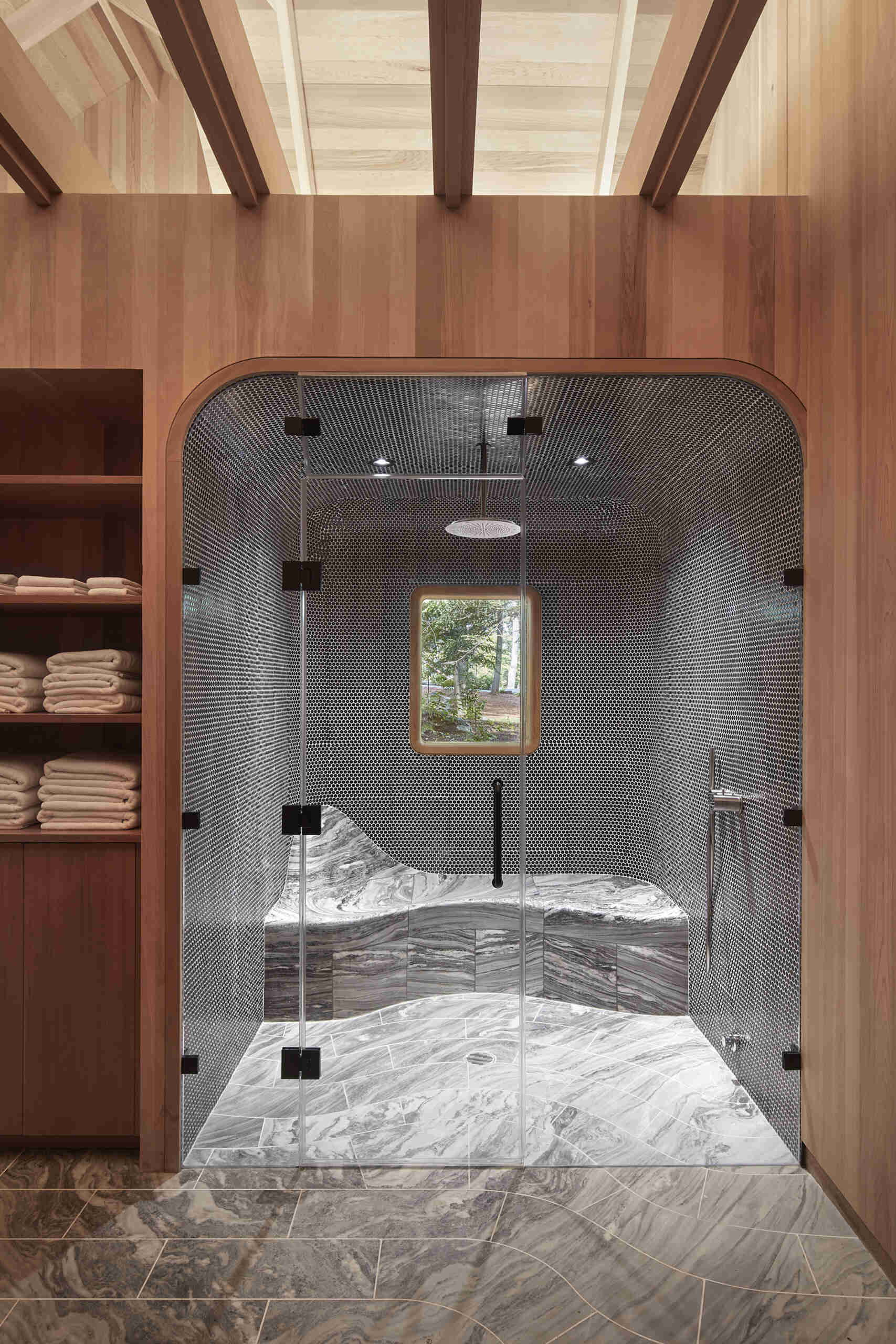 PARTISANS transformed a modest ice-storage hut on a Muskoka island into a compact thermal spa filled with carved Canadian Shield granite, custom-milled cedar, a sauna, cold plunge and steam room, as well as an outdoor patio with outdoor shower.
