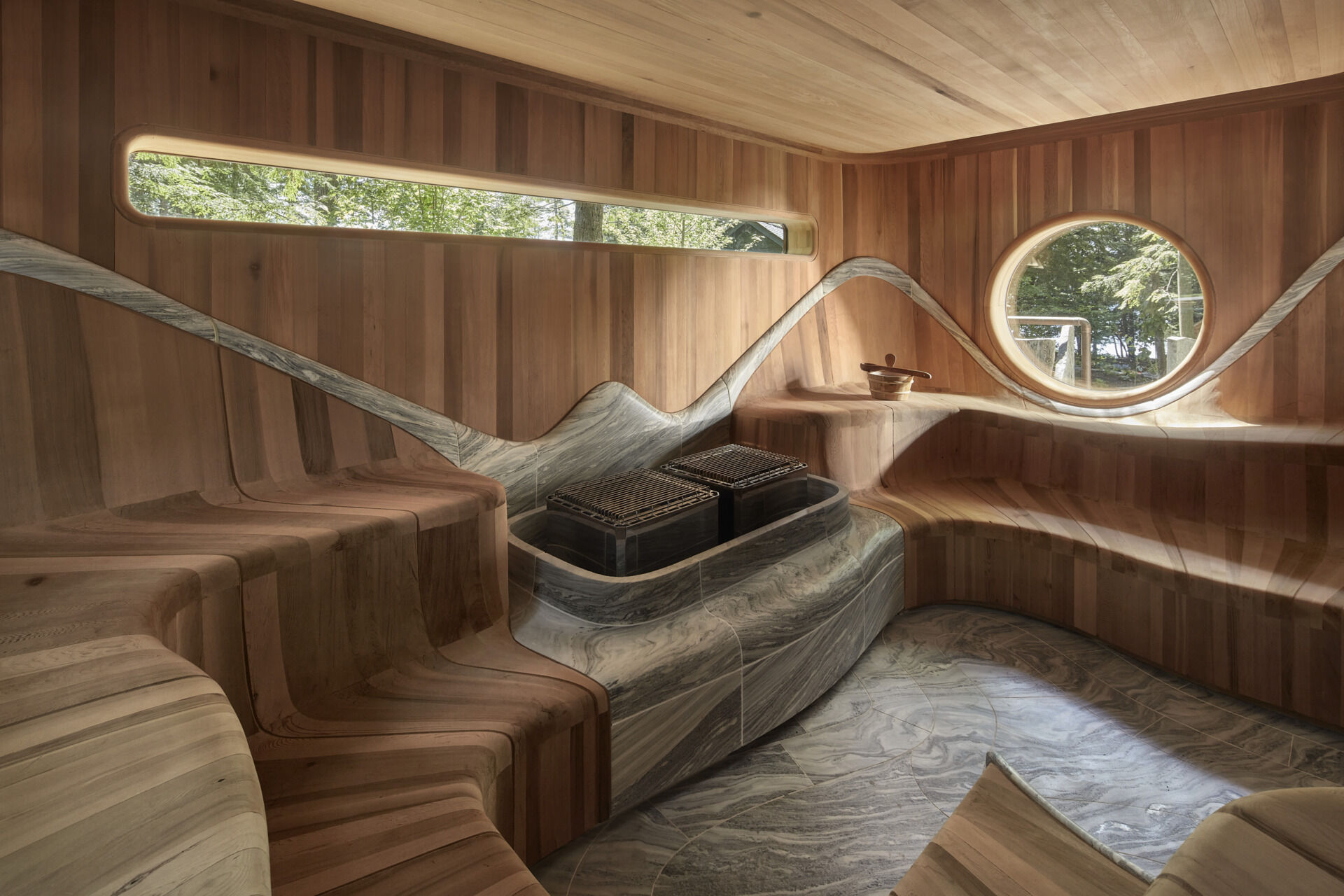 PARTISANS transformed a modest ice-storage hut on a Muskoka island into a compact thermal spa filled with carved Canadian Shield granite, custom-milled cedar, a sauna, cold plunge and steam room, as well as an outdoor patio with outdoor shower.