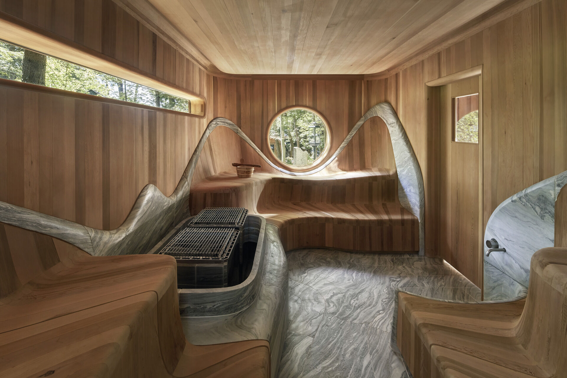 PARTISANS transformed a modest ice-storage hut on a Muskoka island into a compact thermal spa filled with carved Canadian Shield granite, custom-milled cedar, a sauna, cold plunge and steam room, as well as an outdoor patio with outdoor shower.