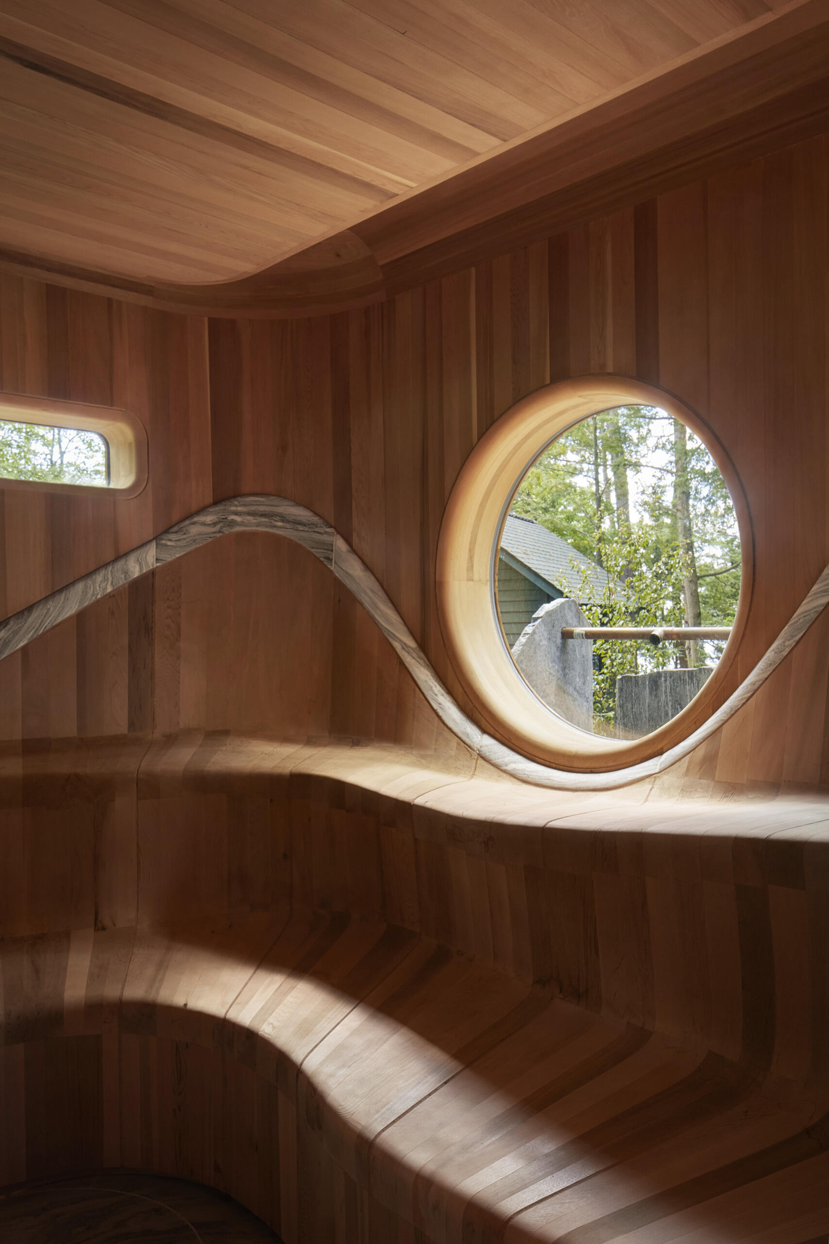 PARTISANS transformed a modest ice-storage hut on a Muskoka island into a compact thermal spa filled with carved Canadian Shield granite, custom-milled cedar, a sauna, cold plunge and steam room, as well as an outdoor patio with outdoor shower.