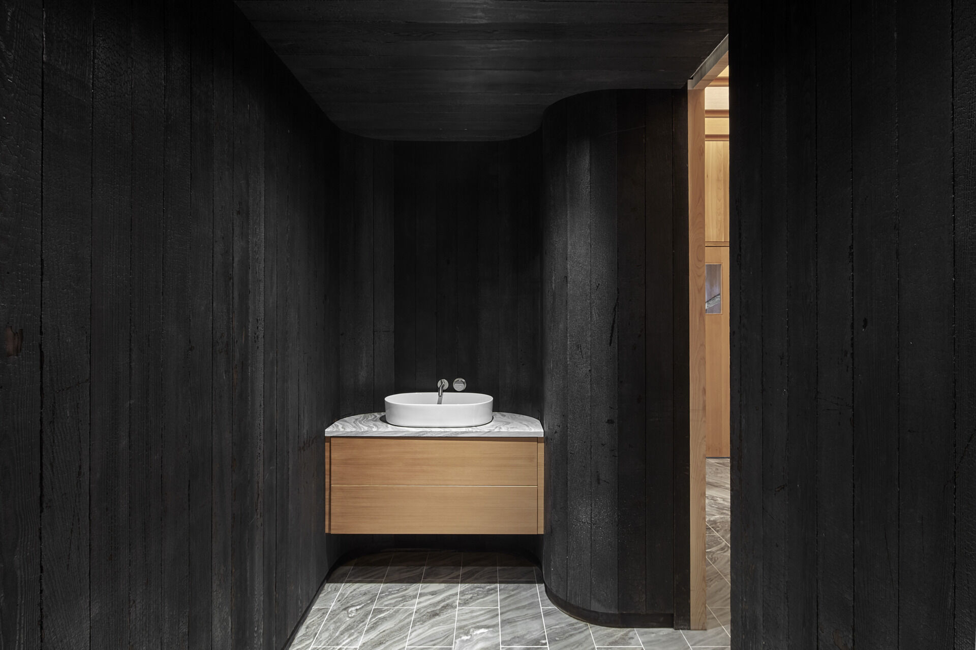 PARTISANS transformed a modest ice-storage hut on a Muskoka island into a compact thermal spa filled with carved Canadian Shield granite, custom-milled cedar, a sauna, cold plunge and steam room, as well as an outdoor patio with outdoor shower.