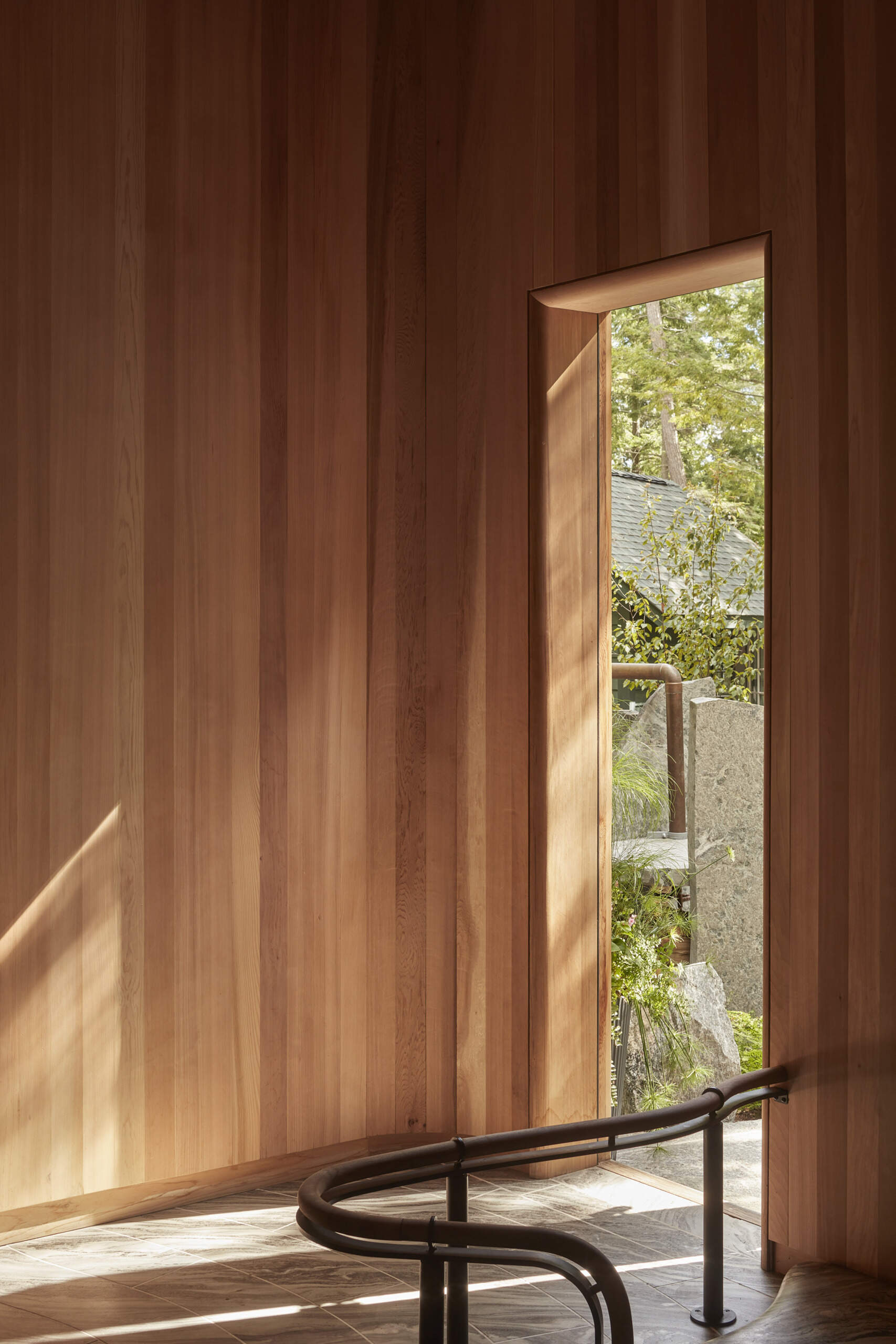 PARTISANS transformed a modest ice-storage hut on a Muskoka island into a compact thermal spa filled with carved Canadian Shield granite, custom-milled cedar, a sauna, cold plunge and steam room, as well as an outdoor patio with outdoor shower.