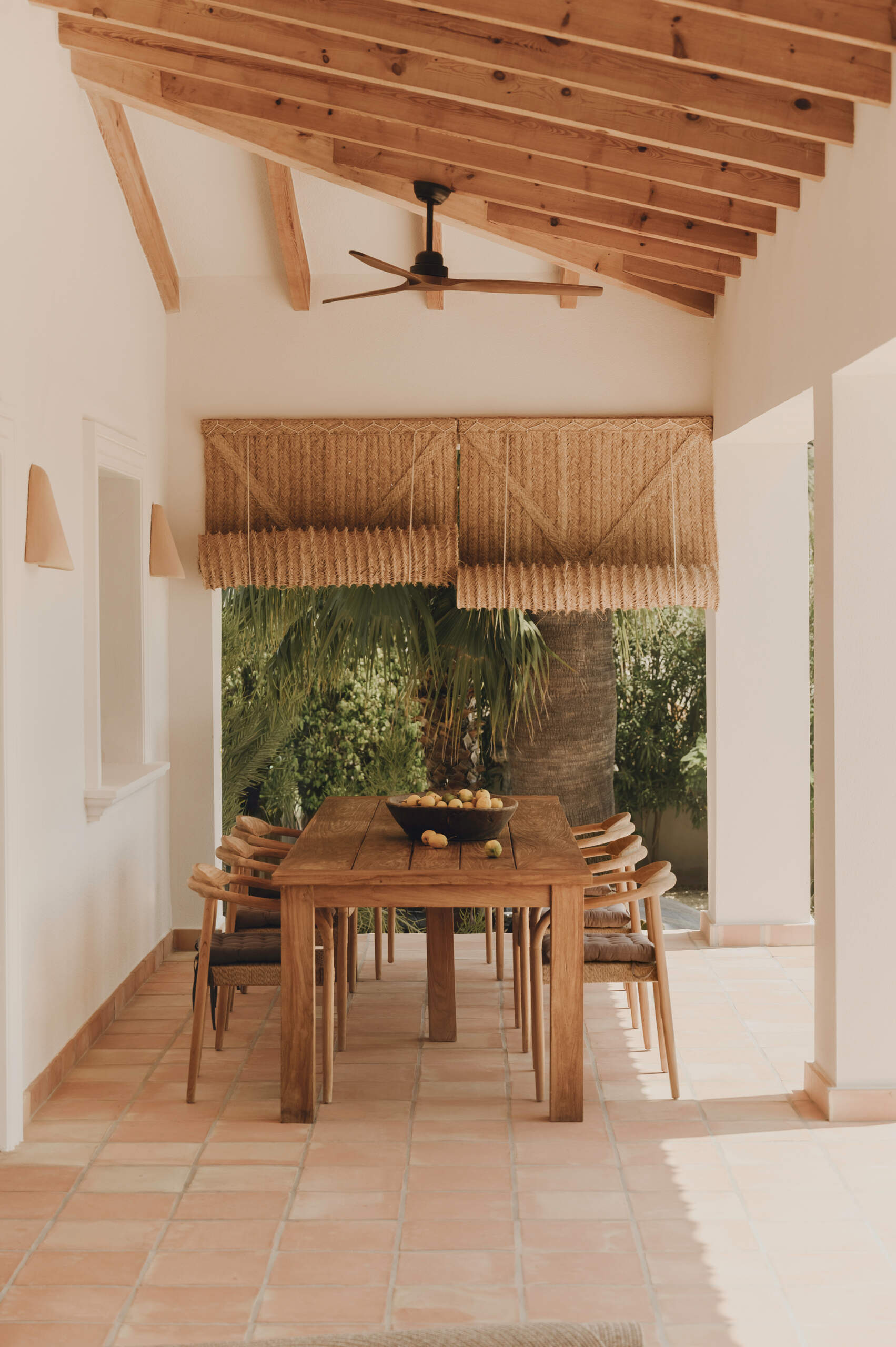 Discover an outdoor dining space and pool that continue the warm Mediterranean feel established throughout the interior.