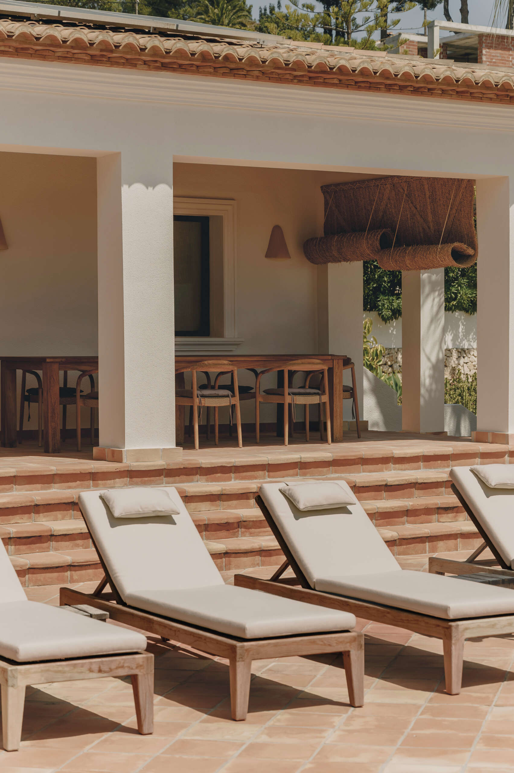 Discover an outdoor dining space and pool that continue the warm Mediterranean feel established throughout the interior.