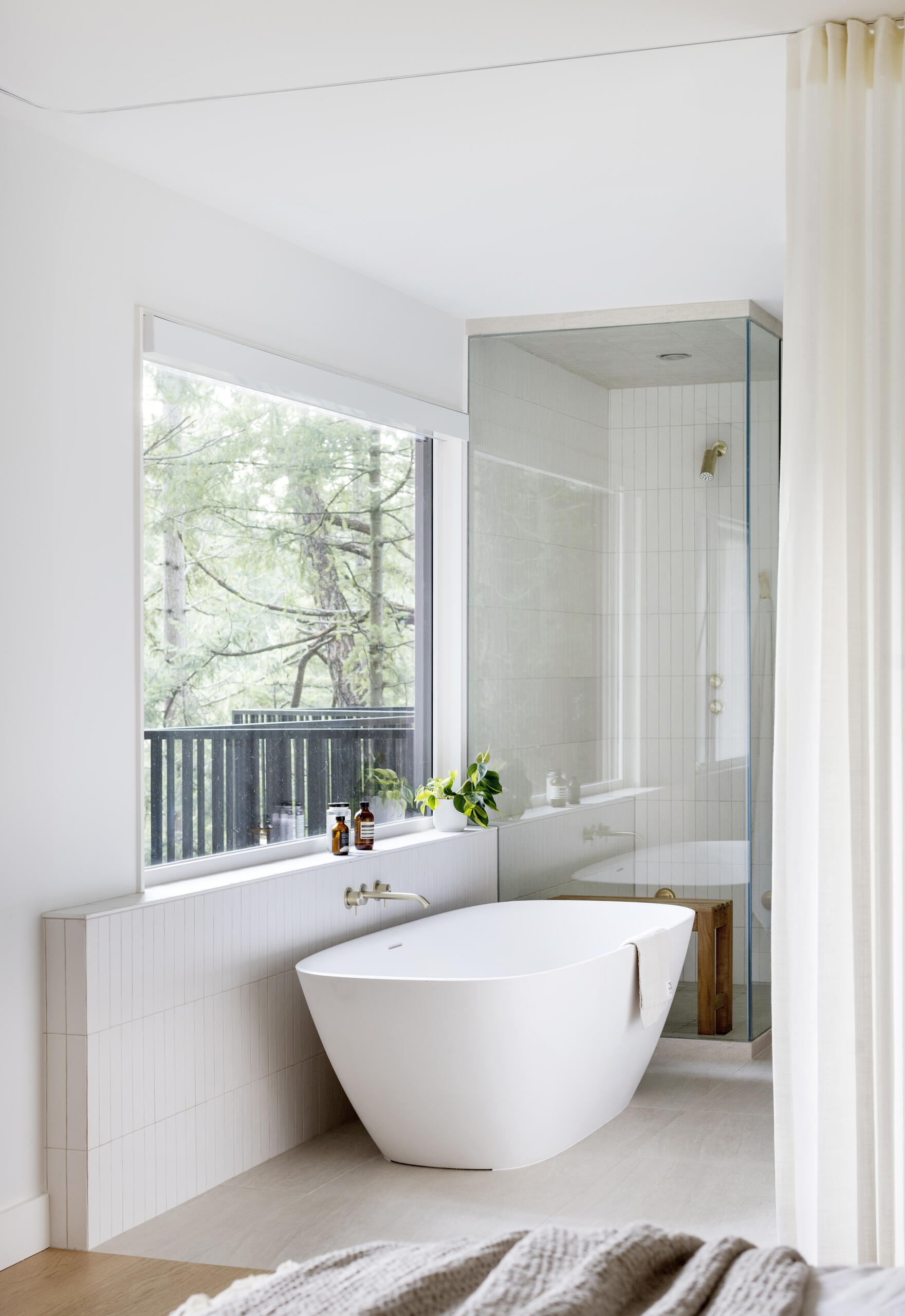 The principal bedroom and ensuite at this West Vancouver mid-century home were expanded and reconfigured, creating a quiet and comfortable part of the house surrounded by forest.