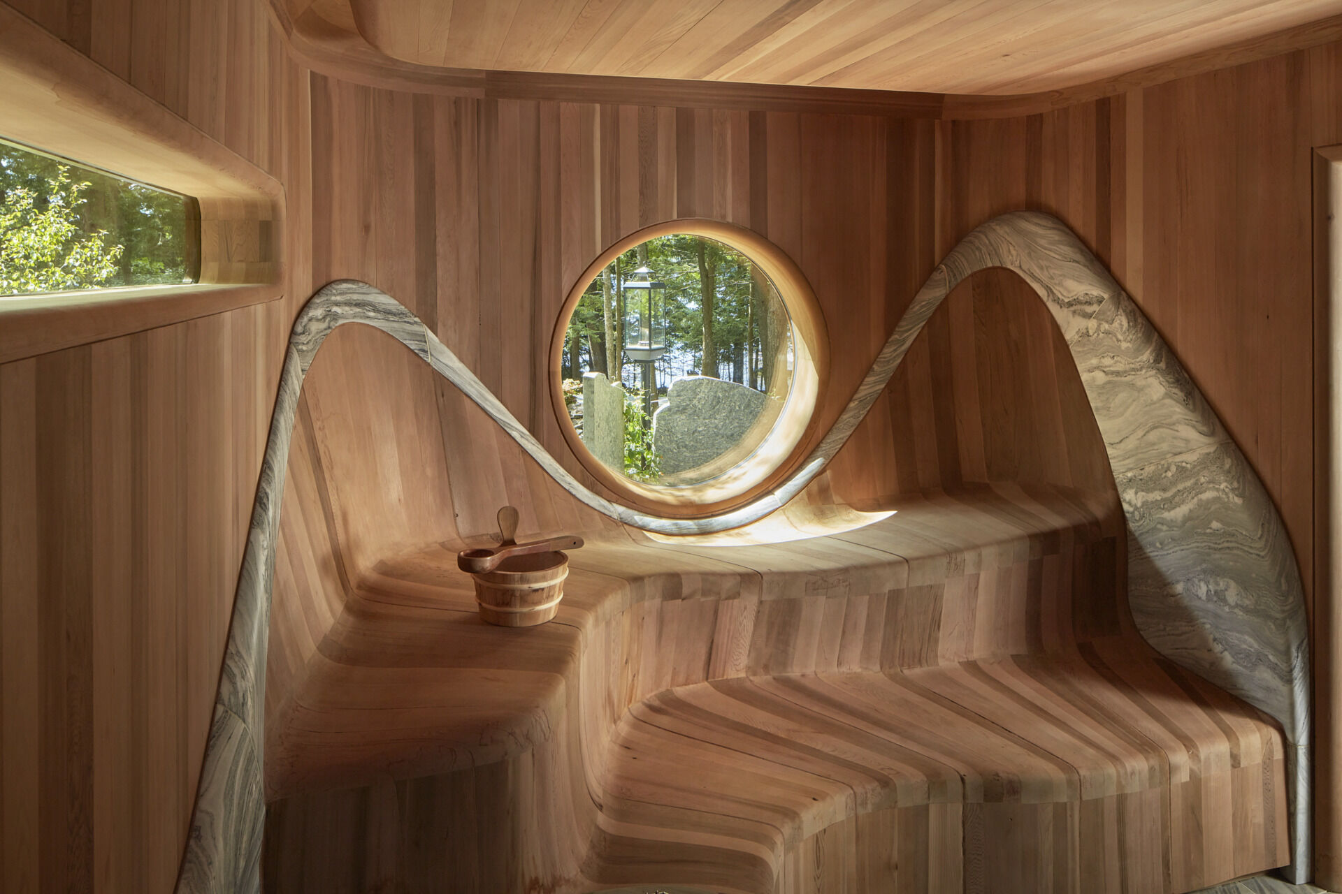 PARTISANS transformed a modest ice-storage hut on a Muskoka island into a compact thermal spa filled with carved Canadian Shield granite, custom-milled cedar, a sauna, cold plunge and steam room, as well as an outdoor patio with outdoor shower.