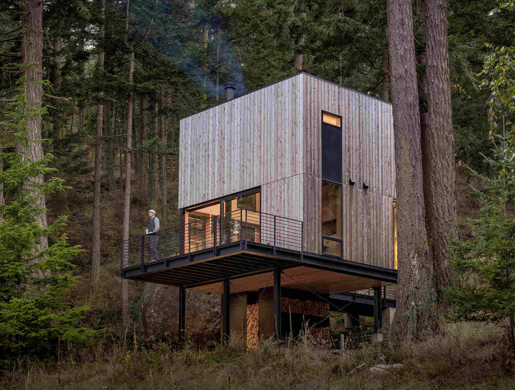 Explore the architecture of a 400-square-foot cabin suspended on stilts above the forest on Blakely Island, Washington, with a compact 16-by-20-foot footprint and expansive water views.