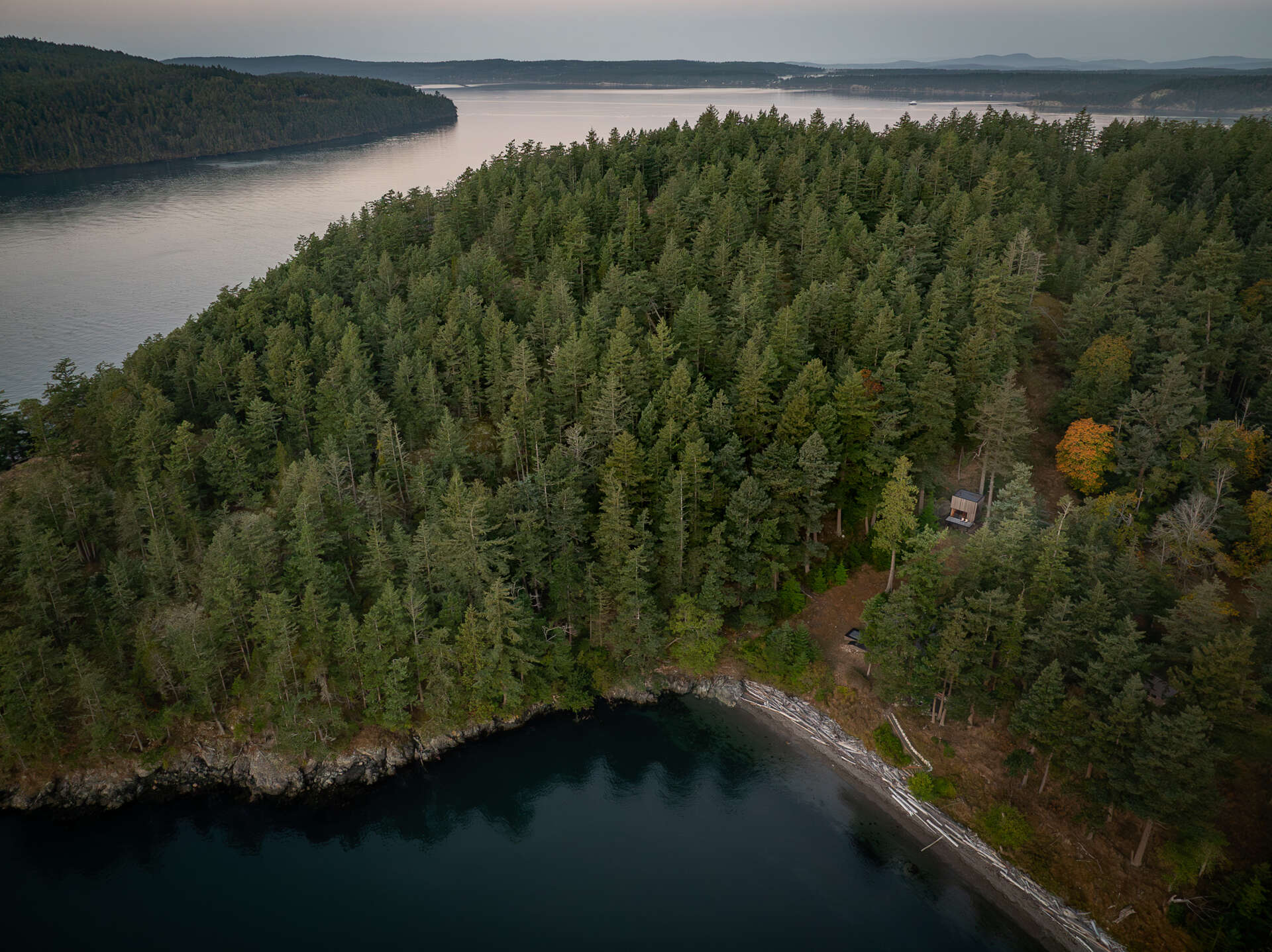 Explore the architecture of a 400-square-foot cabin suspended on stilts above the forest on Blakely Island, Washington, with a compact 16-by-20-foot footprint and expansive water views.