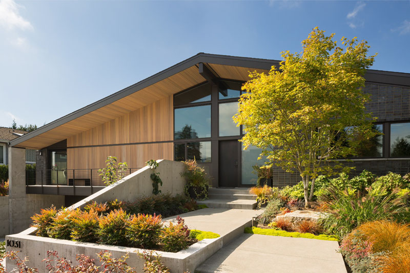 A contemporary Bellevue home by Lane Williams Architects combines charcoal grey brick, cedar siding and aluminum windows with landscaping inspired by the home's mid-century neighborhood.