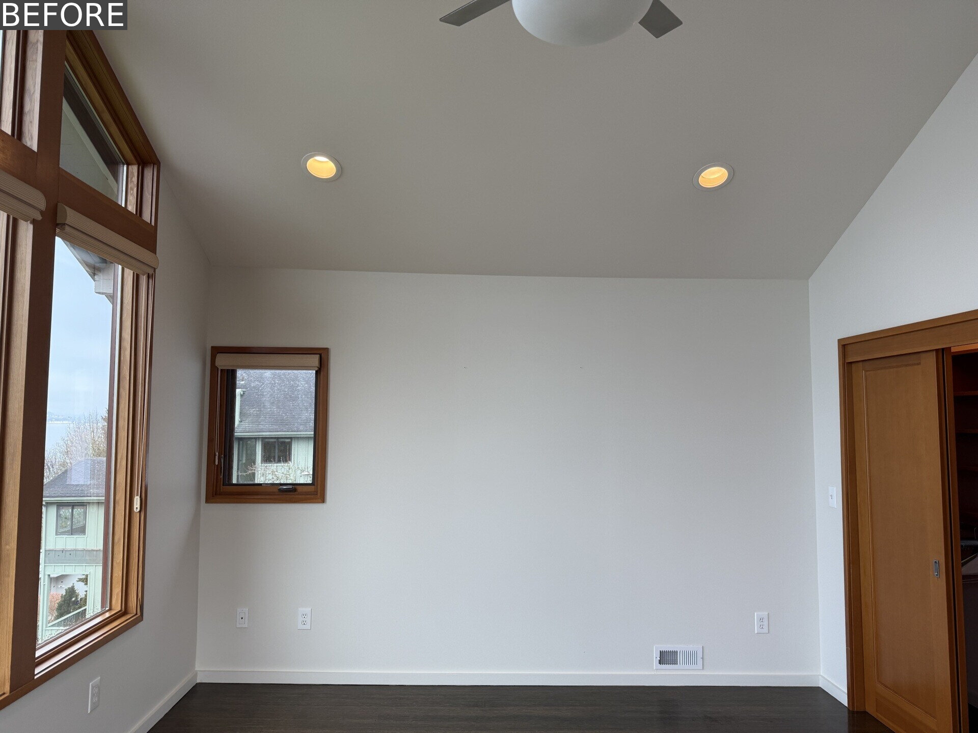 Tour the primary bedroom at Alki Lookout, where SHED paired existing panoramic Puget Sound windows with pale timber built-ins, a custom bed platform, concealed drawers and a pink-cushioned window bench.