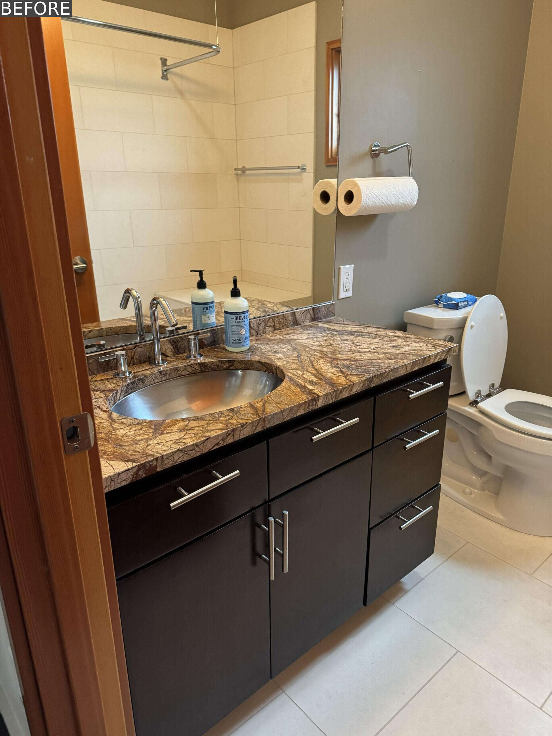 See the guest bathroom before and after, transformed from a neutral space into a playful blue room with wave-pattern tile, sea creature wallpaper, pale timber cabinetry, terrazzo and a translucent yellow shower curtain.