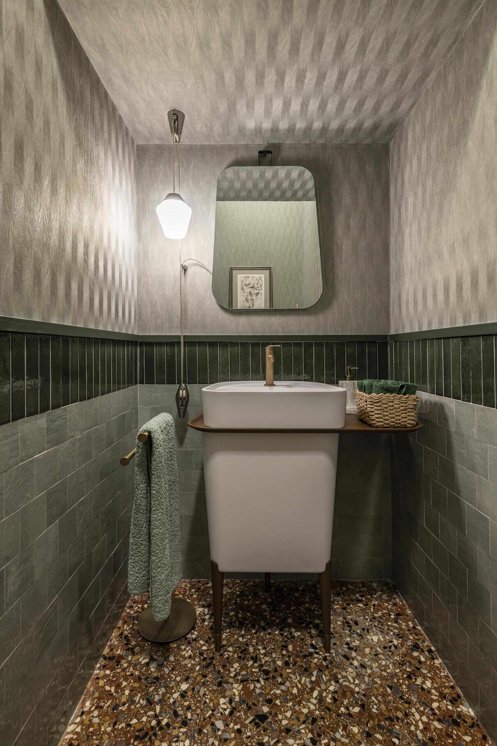 A family-friendly Italian apartment where durable surfaces, warm materials, brass, wood and rich colours create an elegant contemporary interior.