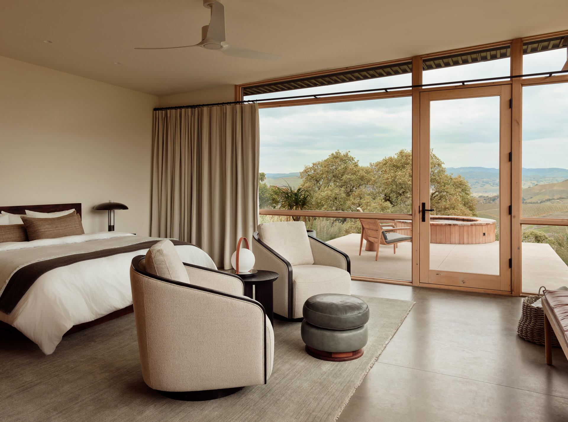 Explore the private bedroom area and nearby hot tub at Vineyard Residence, where the compact plan continues its direct relationship between interior rooms and sheltered outdoor spaces.