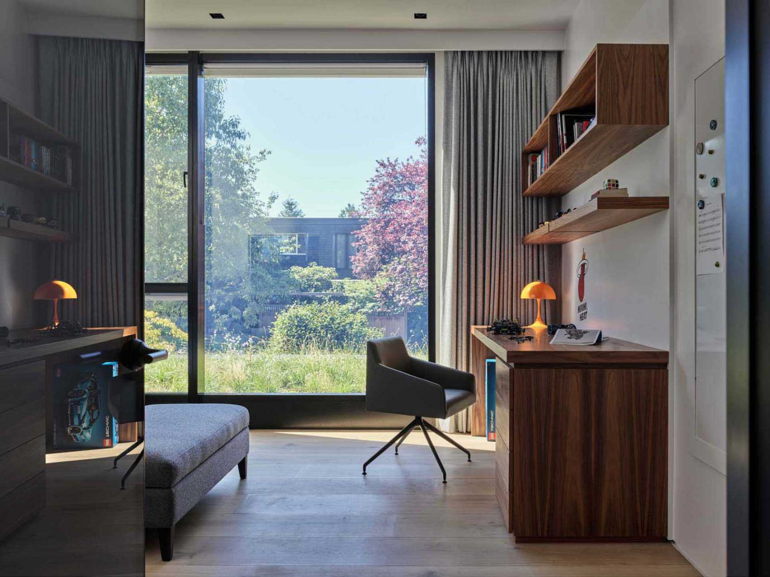 Two bedrooms in Nanton House feature built-in desks, creating dedicated study areas within the warm, contemporary interiors of this multi-generational Vancouver home.