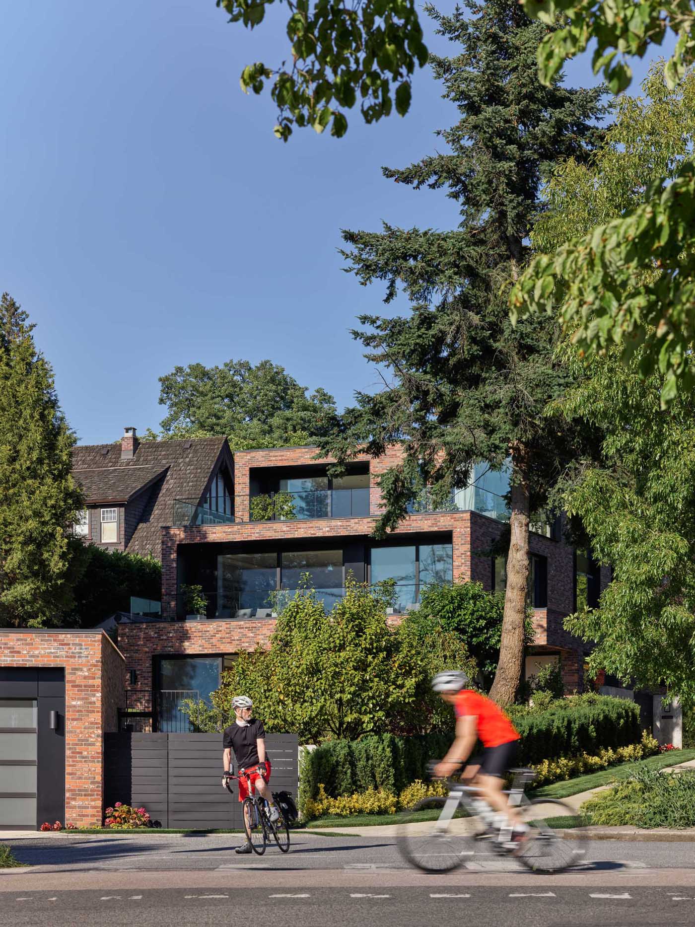 This terraced Vancouver home follows the natural slope of its site, with broad stepped terraces extending the interior spaces outdoors and opening the house toward western views.