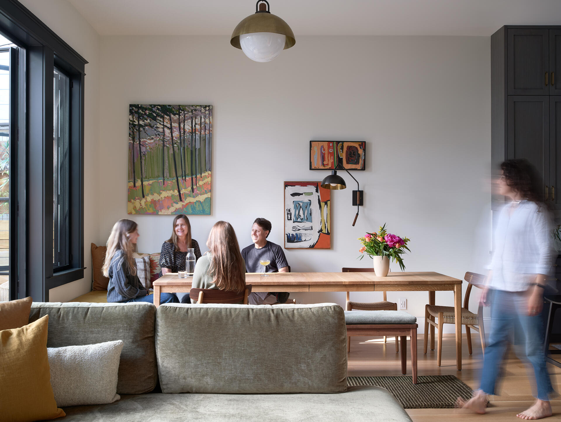 A custom dining table comfortably seats four but expands for larger gatherings, forming part of the open kitchen, living and dining area in this Russian Hill remodel.