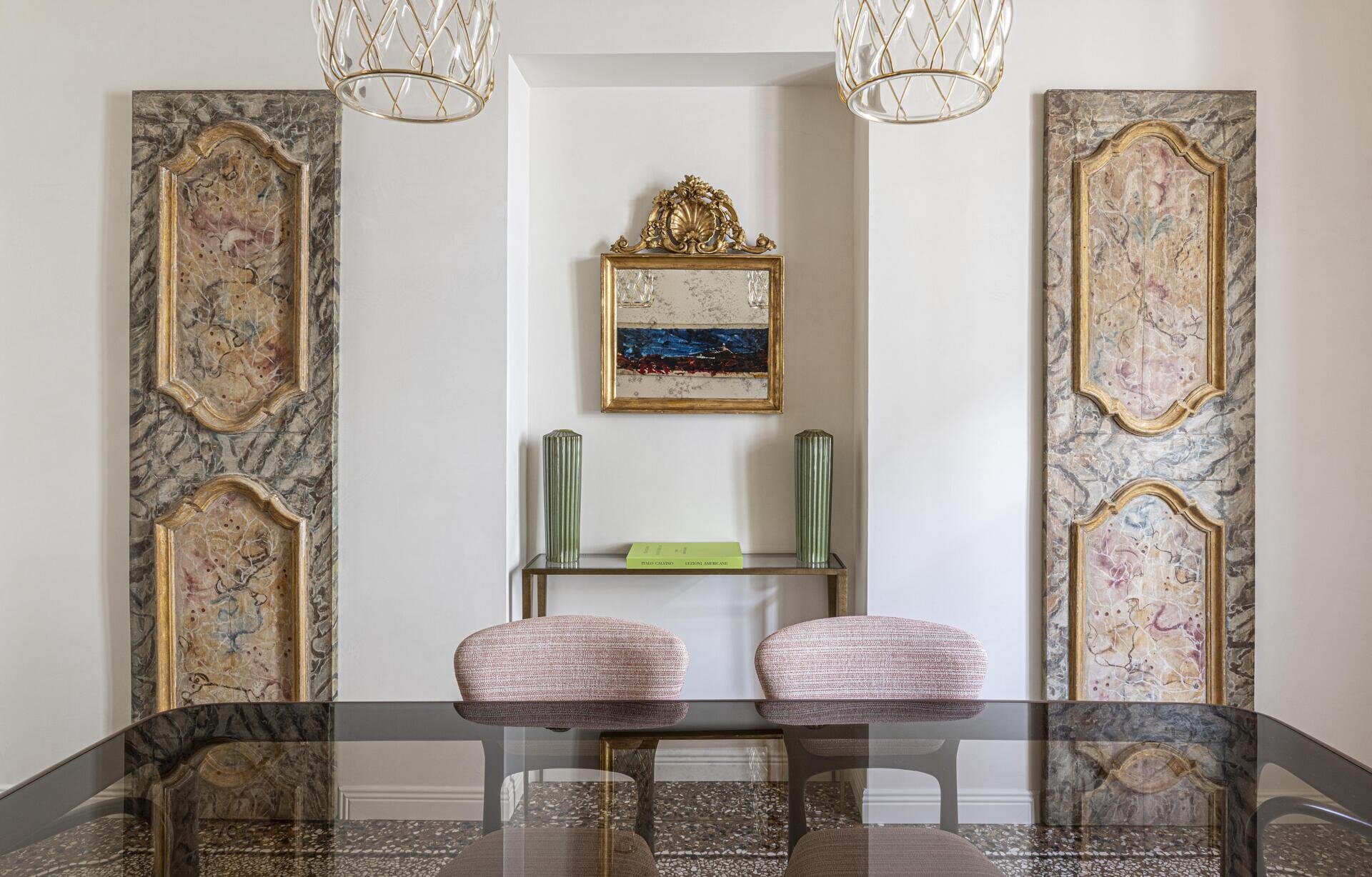 An elegant Italian dining room combines antique wardrobe panels with delicate woven chandeliers, gold details and contemporary dining furniture.