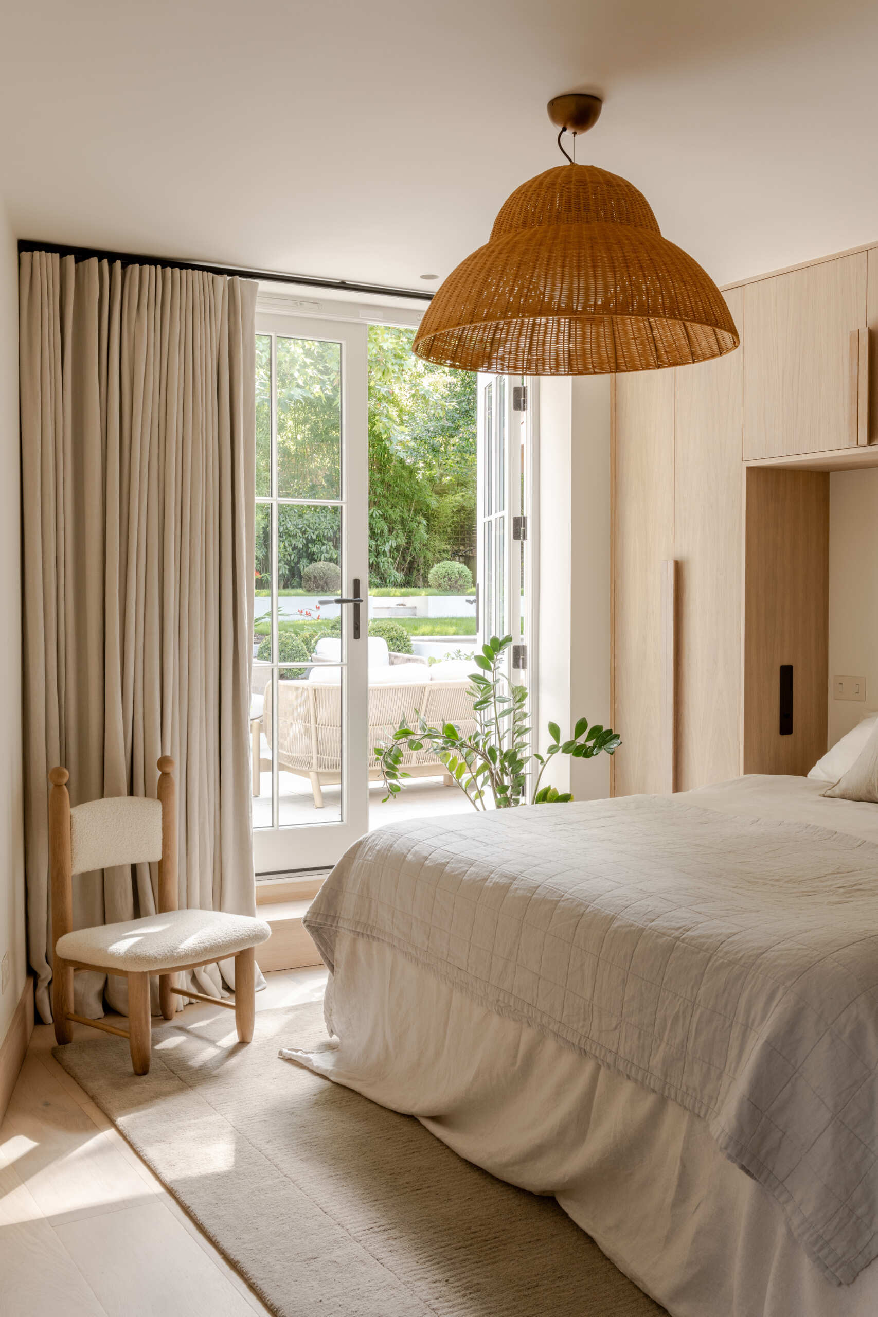 Discover the guest bedroom at Thirsk Cottage, positioned beside the patio and garden for a close connection between the private interior and outdoor space.