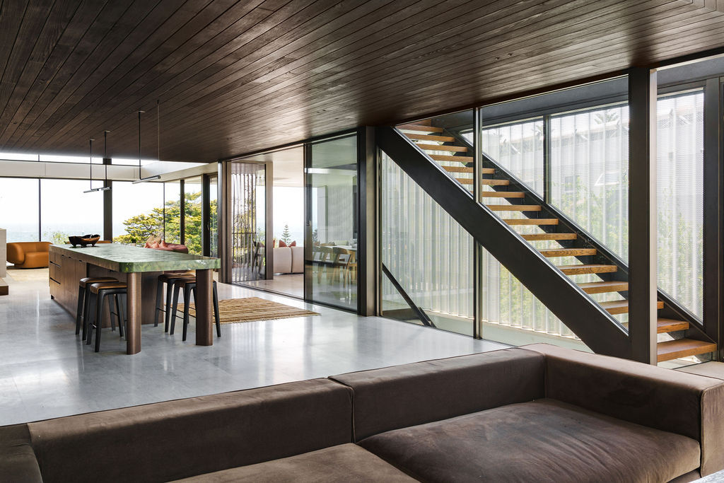 Mezzanine House features two distinctive staircases, combining floating timber treads, black metal, glass balustrades and natural light within the contemporary Perth home.