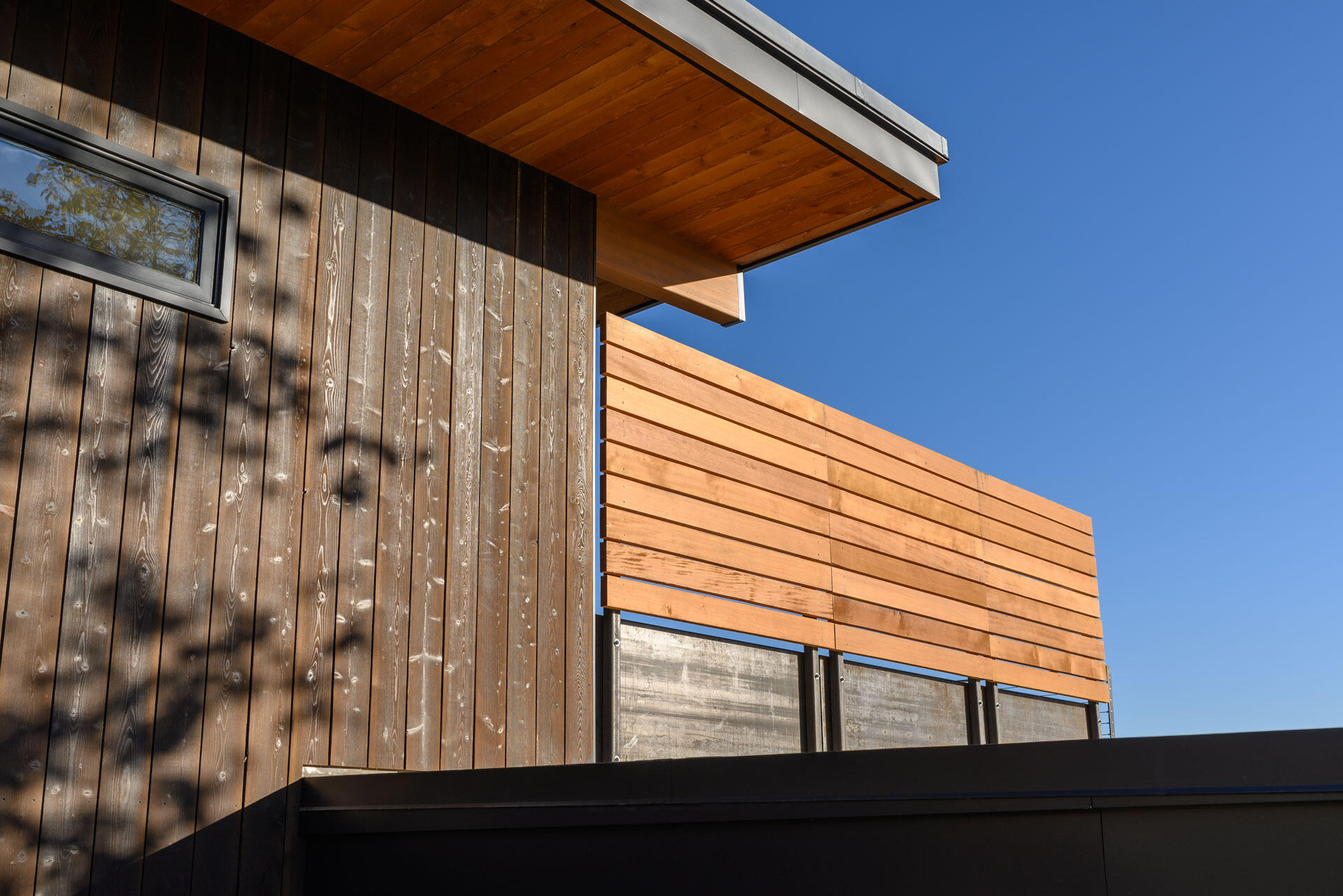 Charred wood siding, raw steel, and warm timber details create a timeless material palette that will naturally weather and develop character over time.