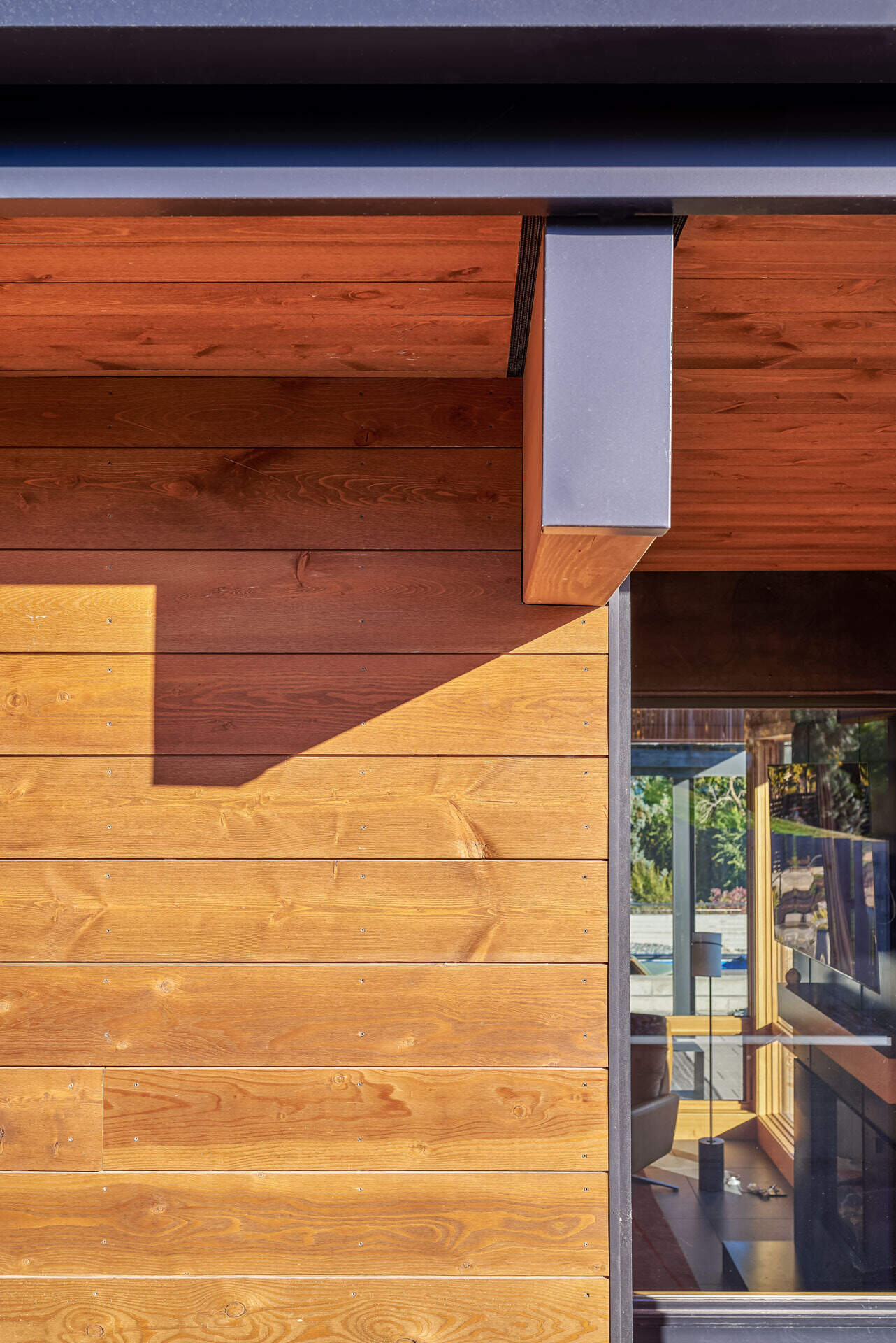 Charred wood siding, raw steel, and warm timber details create a timeless material palette that will naturally weather and develop character over time.