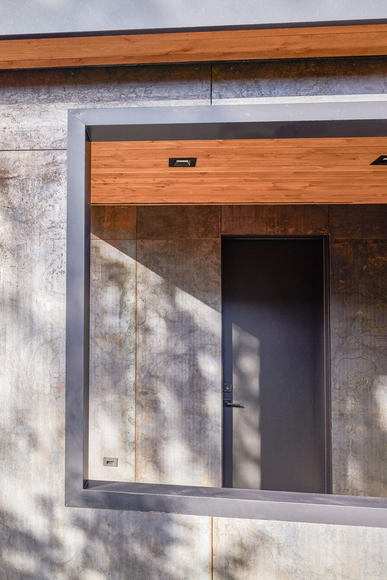Charred wood siding, raw steel, and warm timber details create a timeless material palette that will naturally weather and develop character over time.