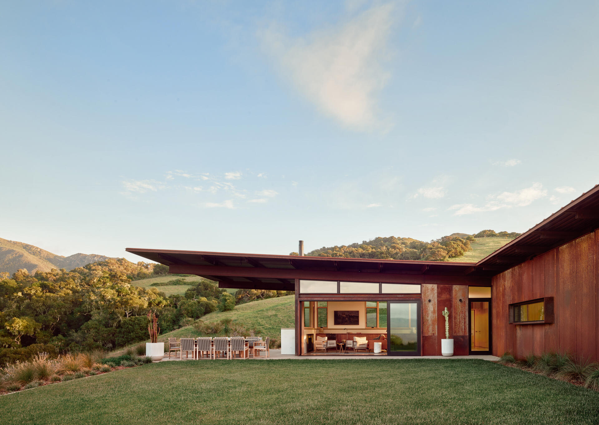 Explore the compact T-shaped plan of Vineyard Residence by Clayton Korte, with private bedroom suites surrounding a central kitchen and living area and outdoor spaces extending at both ends.