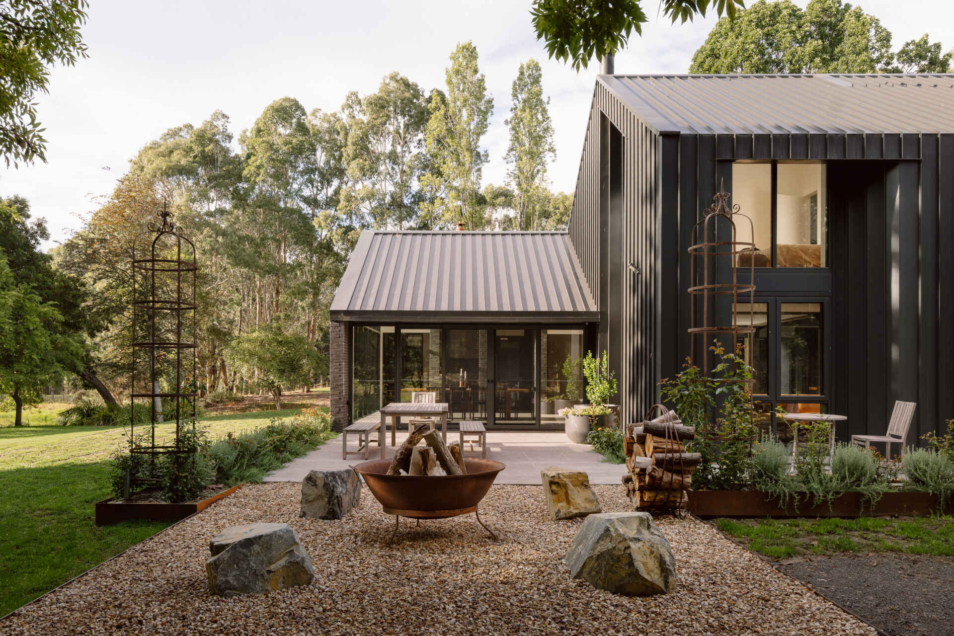 Explore the dark masonry and metal palette of Yarra Valley House, where durable exterior materials meet the practical demands of bushfire-resistant Australian architecture.