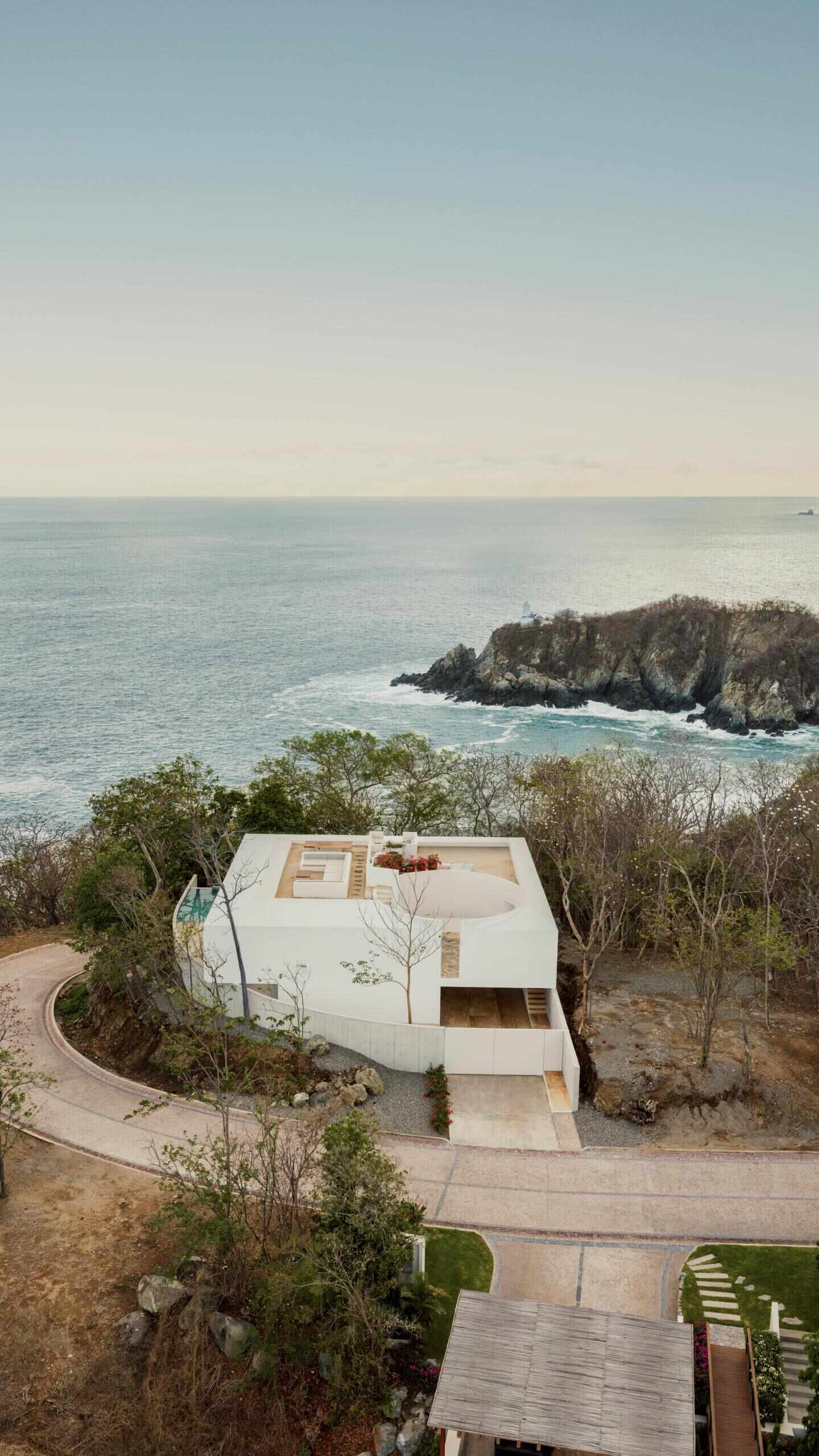 Casa Malonic in Zihuatanejo, Mexico, designed by HW Studio, uses white walls, sandy floors, shade and simple architectural forms to create a home shaped by the surrounding sea and jungle.