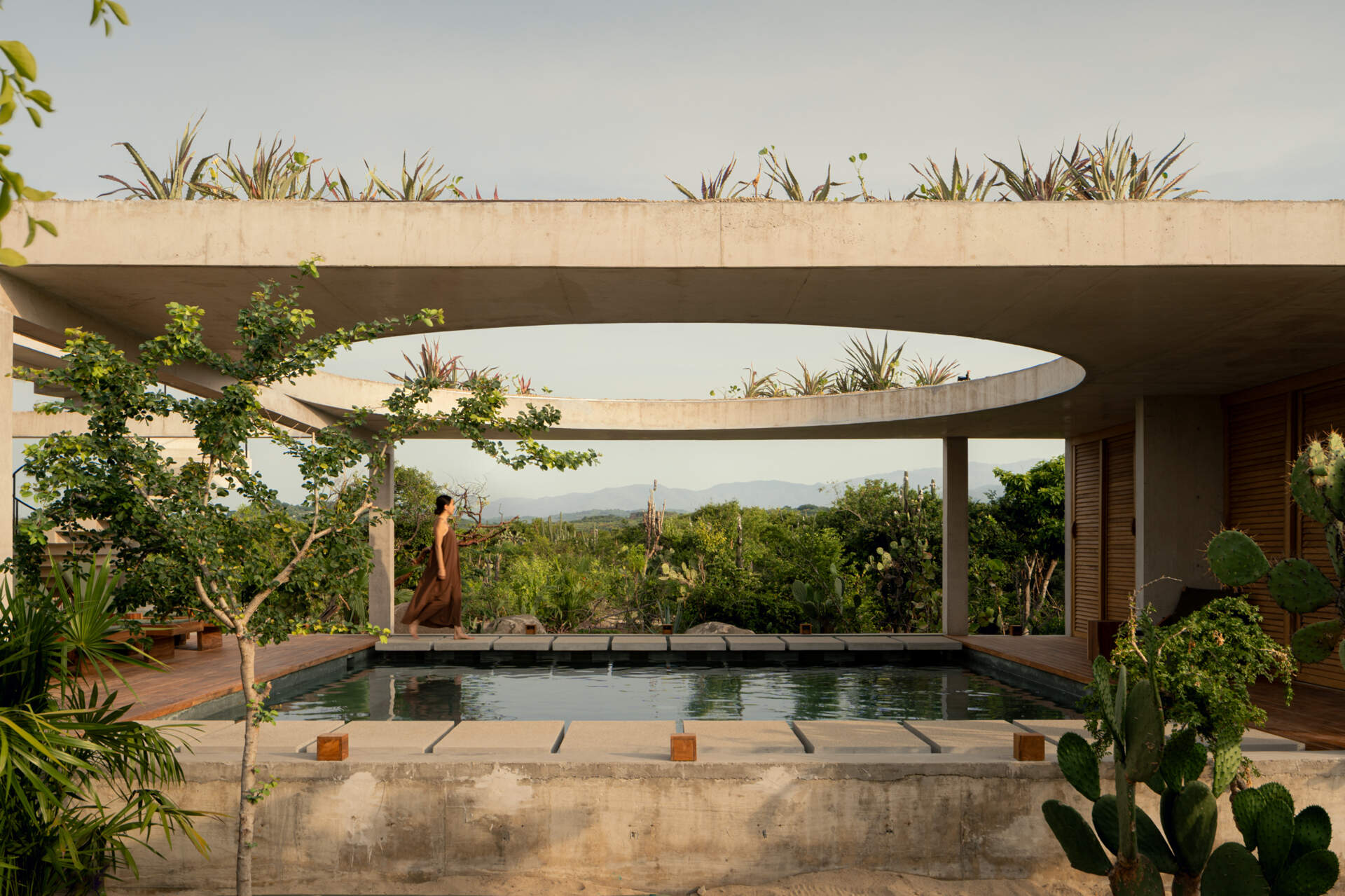 A circular opening above Casa Cieno's central pool frames the sky and brings changing sunlight into the home throughout the day.