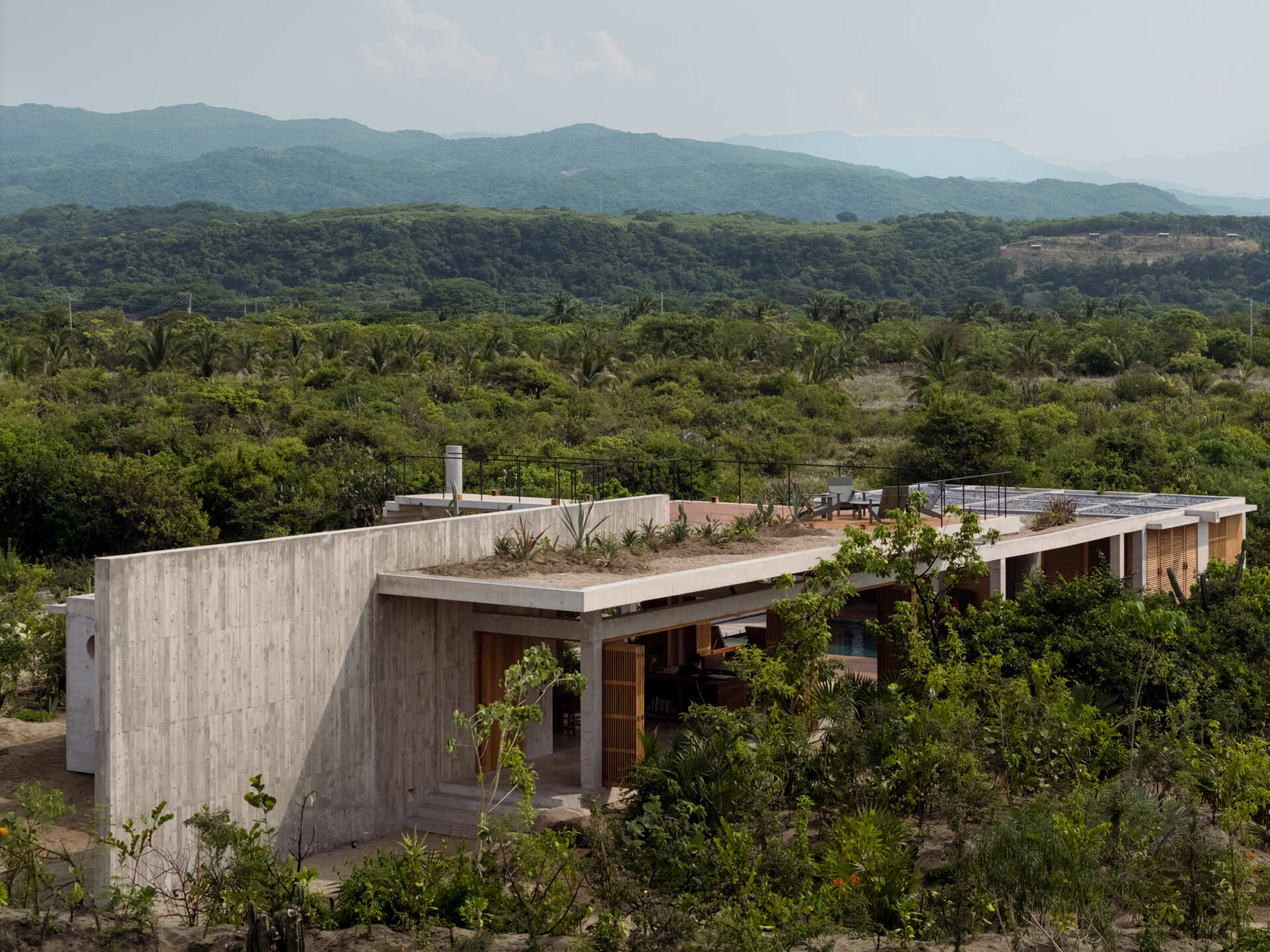 Casa Cieno uses a diagonal building layout to create green patios around the home, adding privacy while surrounding the architecture with lush vegetation.