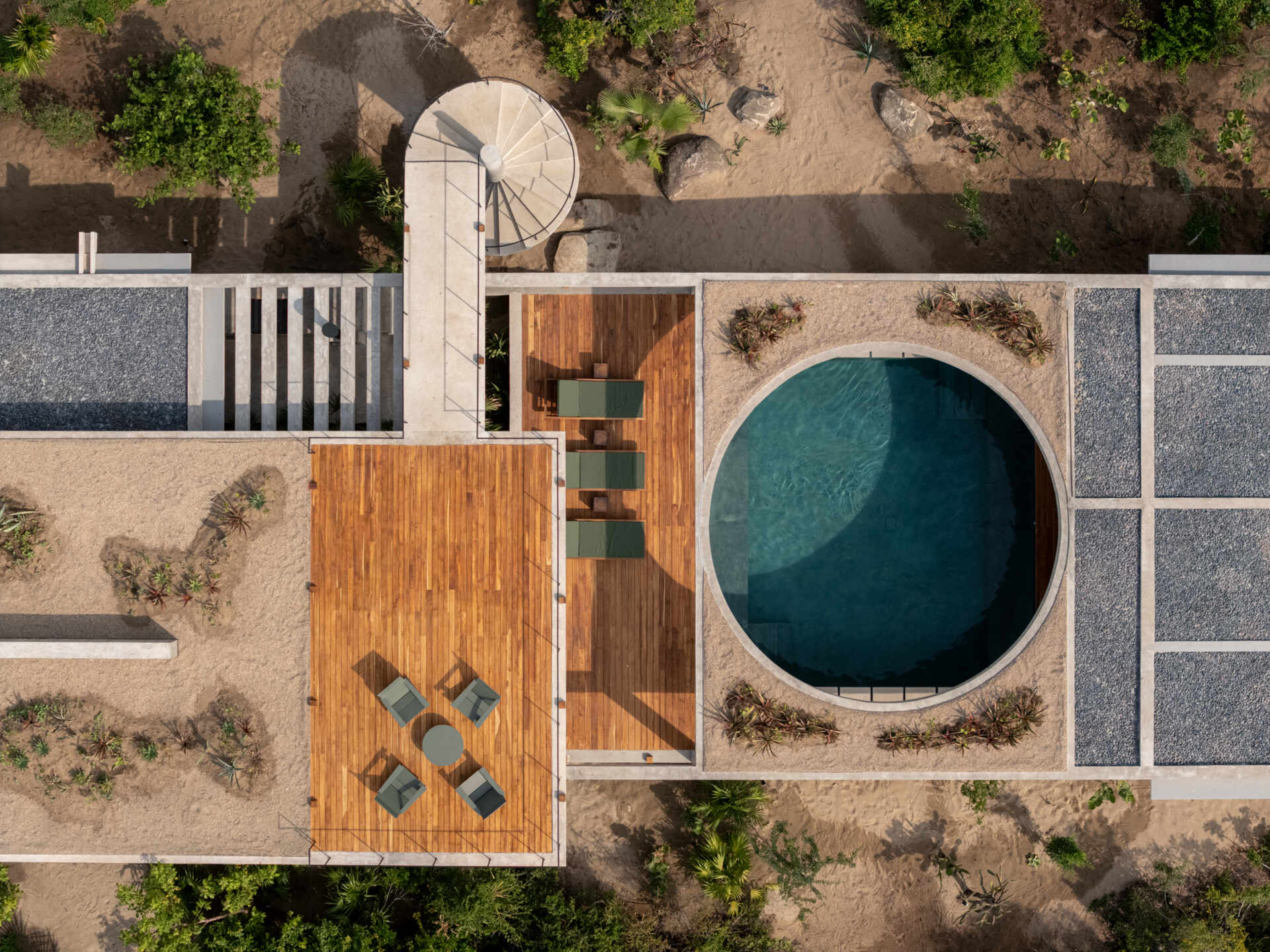 The Casa Cieno floor plan places the central pool between the social and private areas, with the two bedrooms reached by paths crossing over the water.