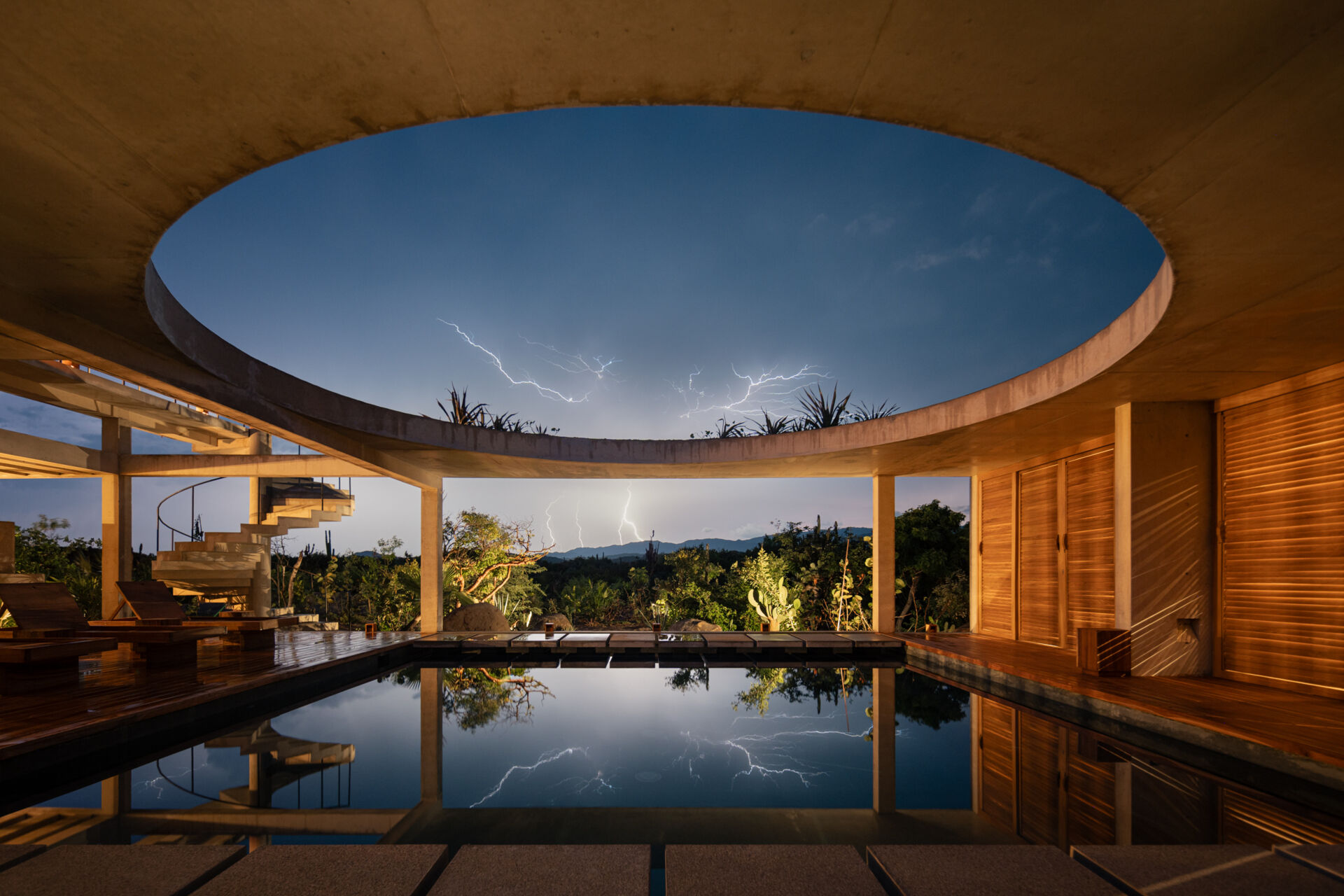 A central pool forms the heart of Casa Cieno, separating the social and private spaces while creating floating pathways between the rooms.