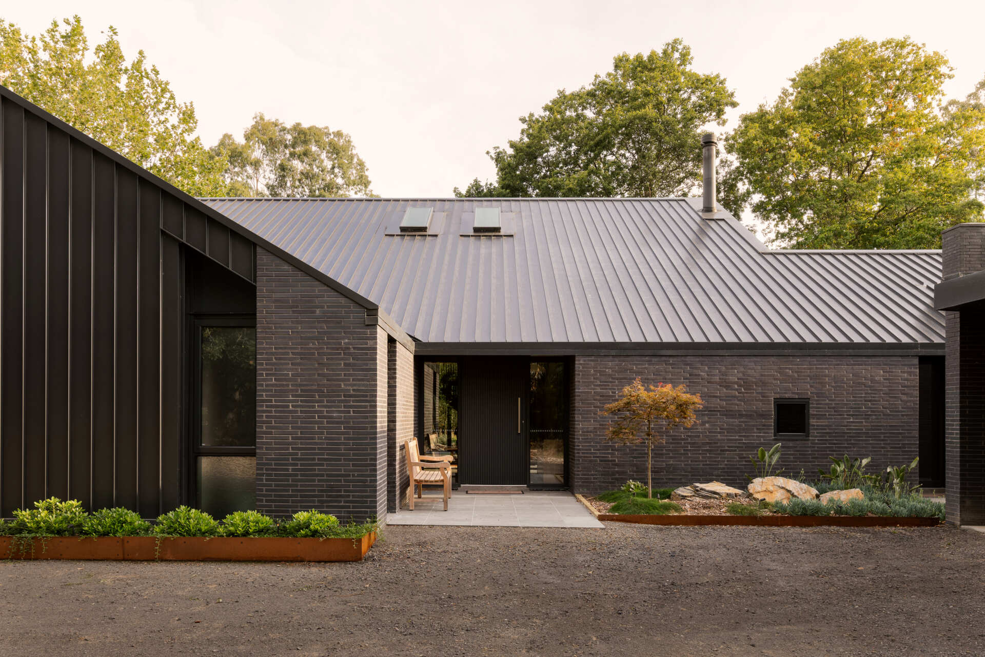 Explore the dark masonry and metal palette of Yarra Valley House, where durable exterior materials meet the practical demands of bushfire-resistant Australian architecture.