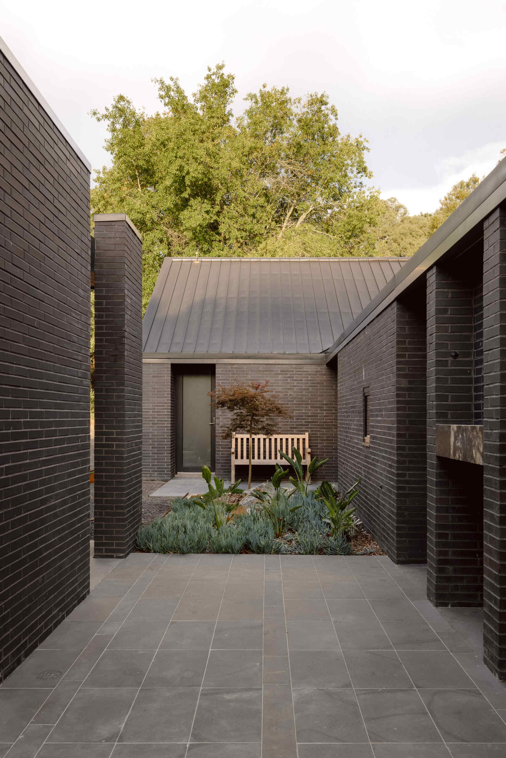 Explore the dark masonry and metal palette of Yarra Valley House, where durable exterior materials meet the practical demands of bushfire-resistant Australian architecture.