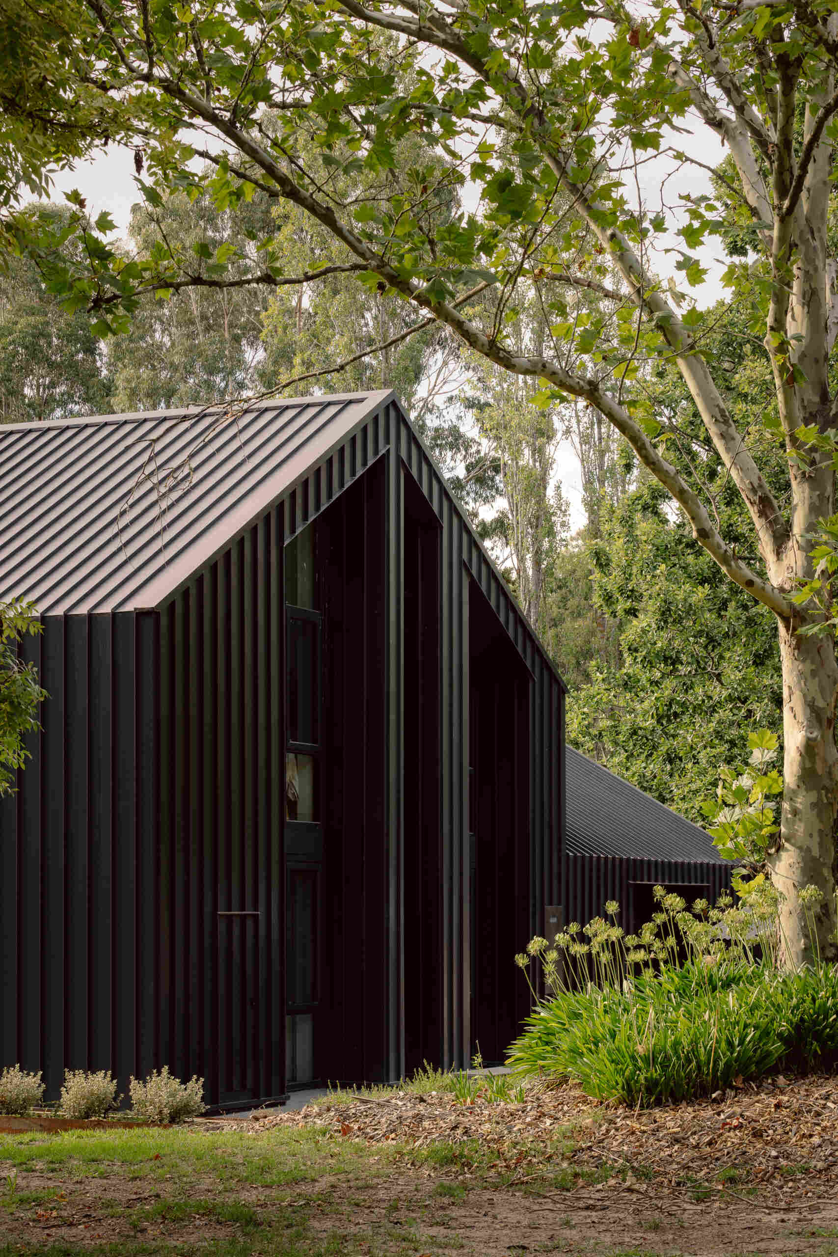 Explore the dark masonry and metal palette of Yarra Valley House, where durable exterior materials meet the practical demands of bushfire-resistant Australian architecture.