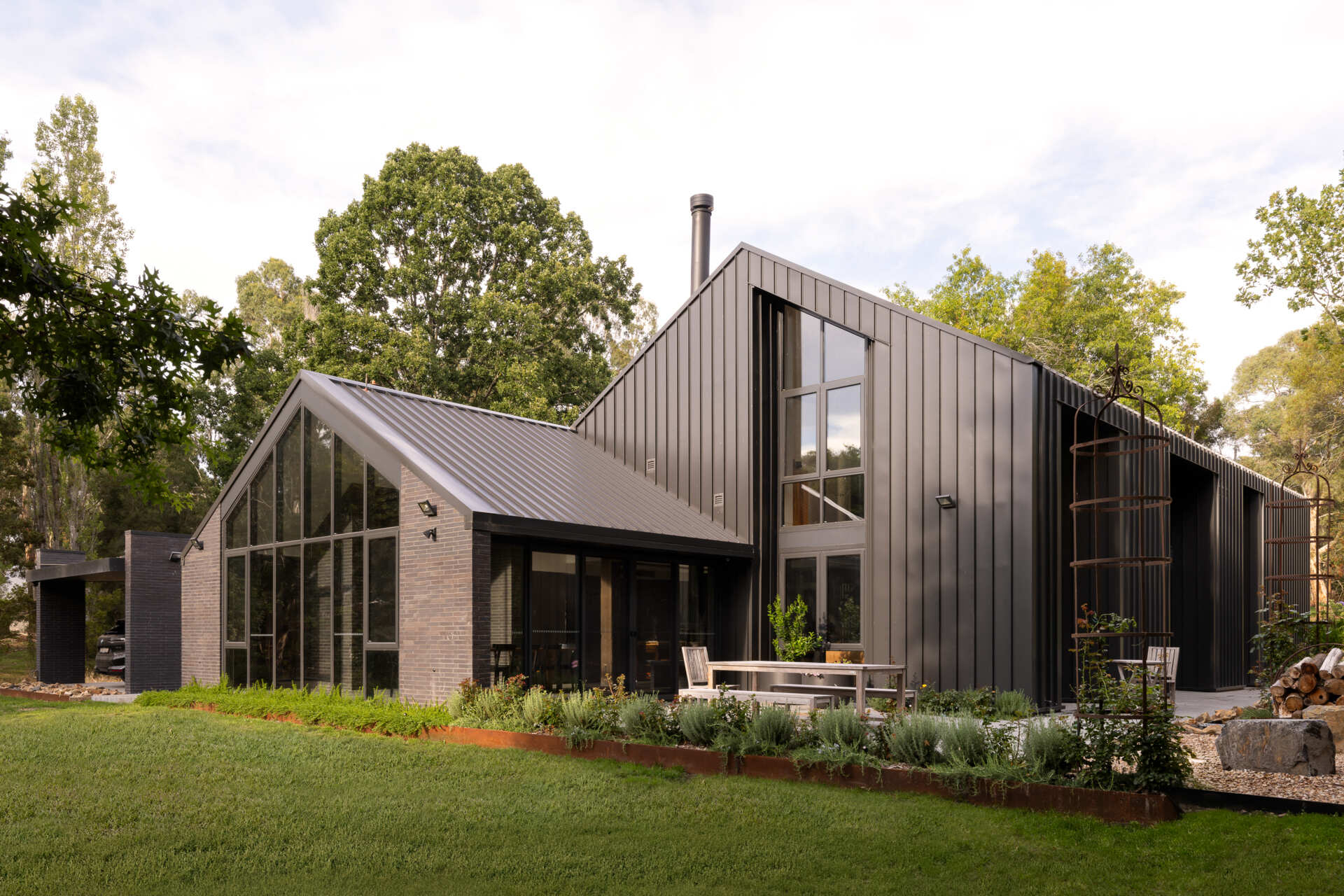 Explore the dark masonry and metal palette of Yarra Valley House, where durable exterior materials meet the practical demands of bushfire-resistant Australian architecture.
