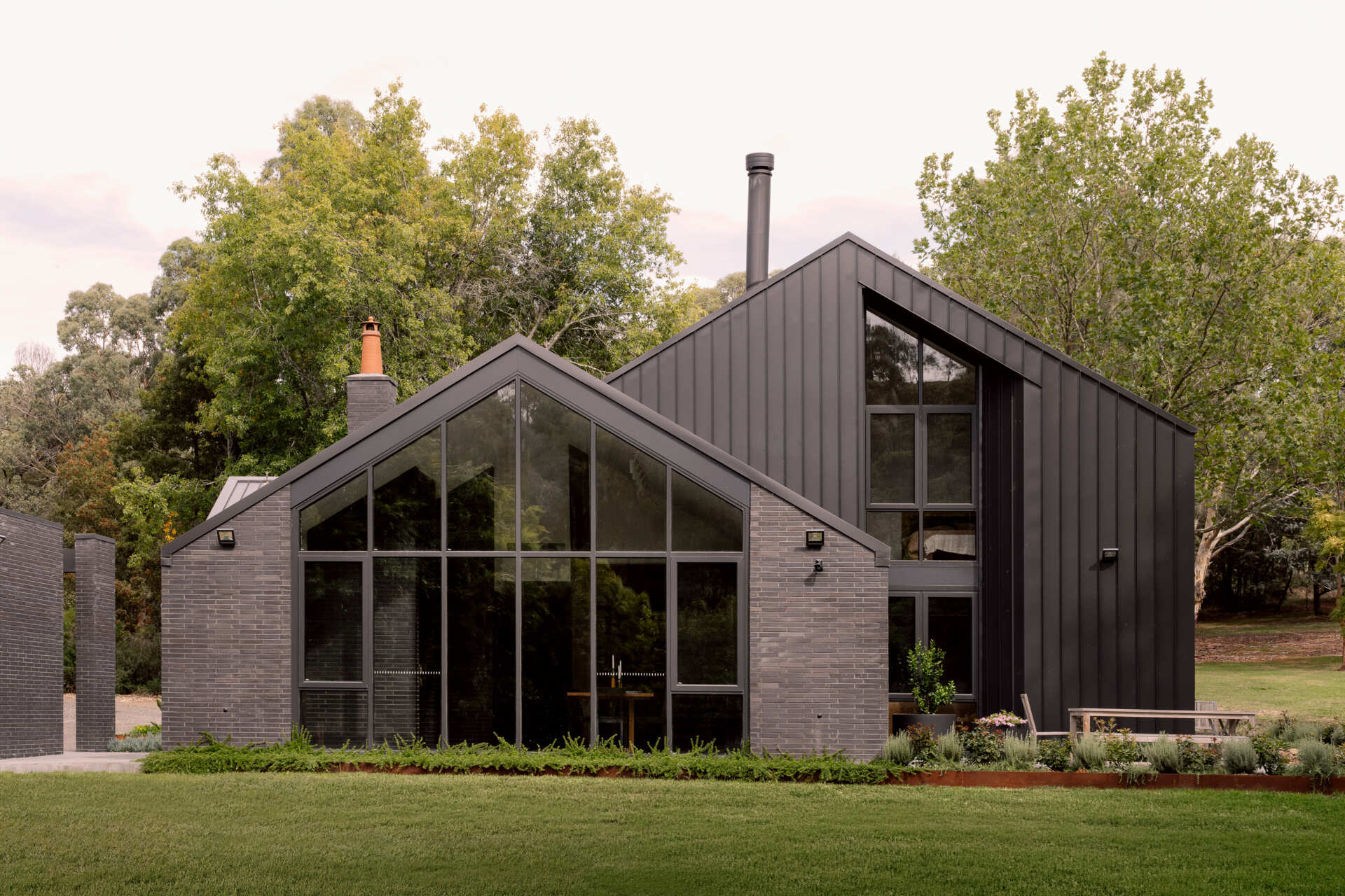 Explore the dark masonry and metal palette of Yarra Valley House, where durable exterior materials meet the practical demands of bushfire-resistant Australian architecture.