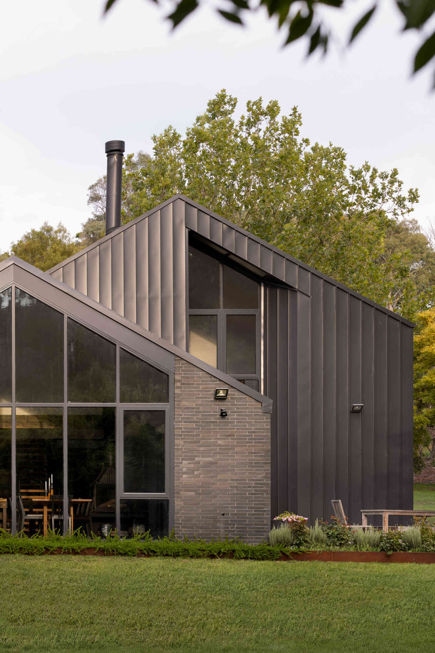 Explore the dark masonry and metal palette of Yarra Valley House, where durable exterior materials meet the practical demands of bushfire-resistant Australian architecture.